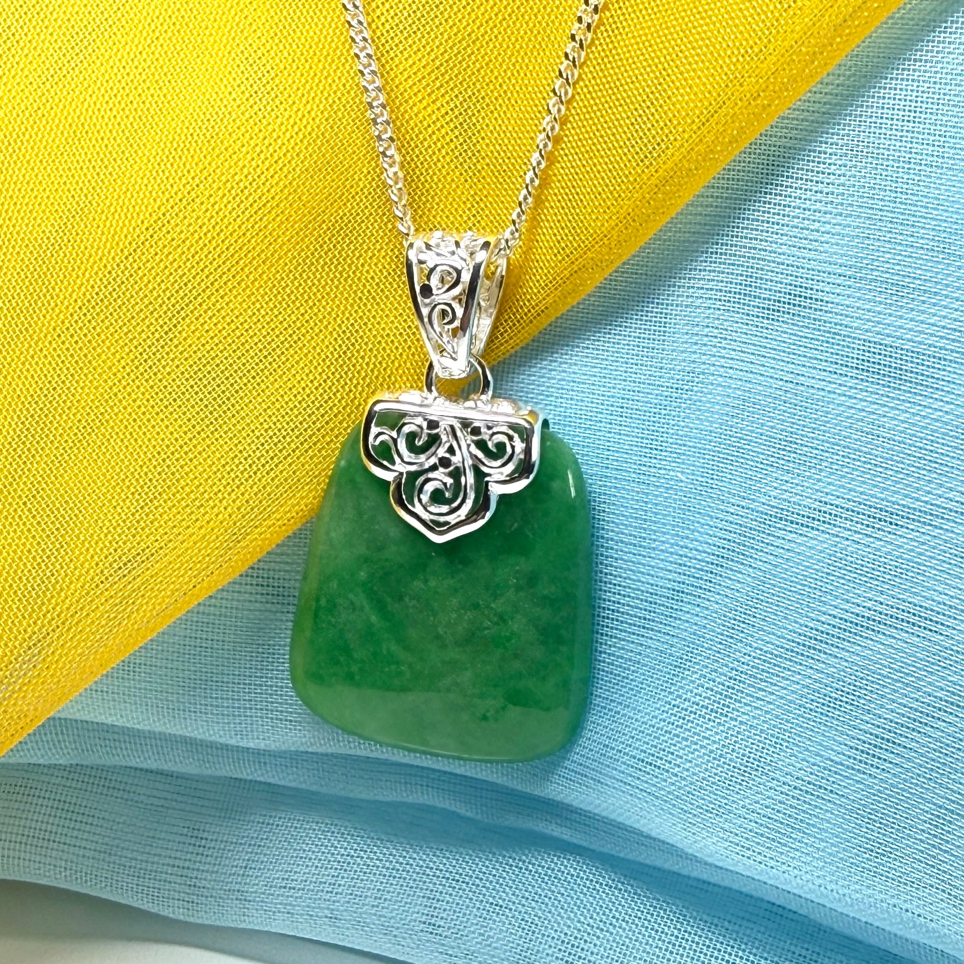 A stunning, a real green jade necklace large shaped with a patterned top pendant