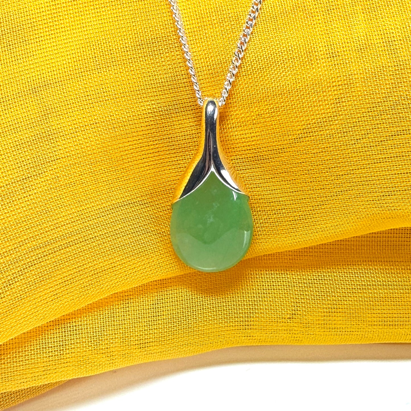 A stunning real green jade necklace in a teardrop, a timeless designed pendant and chain included