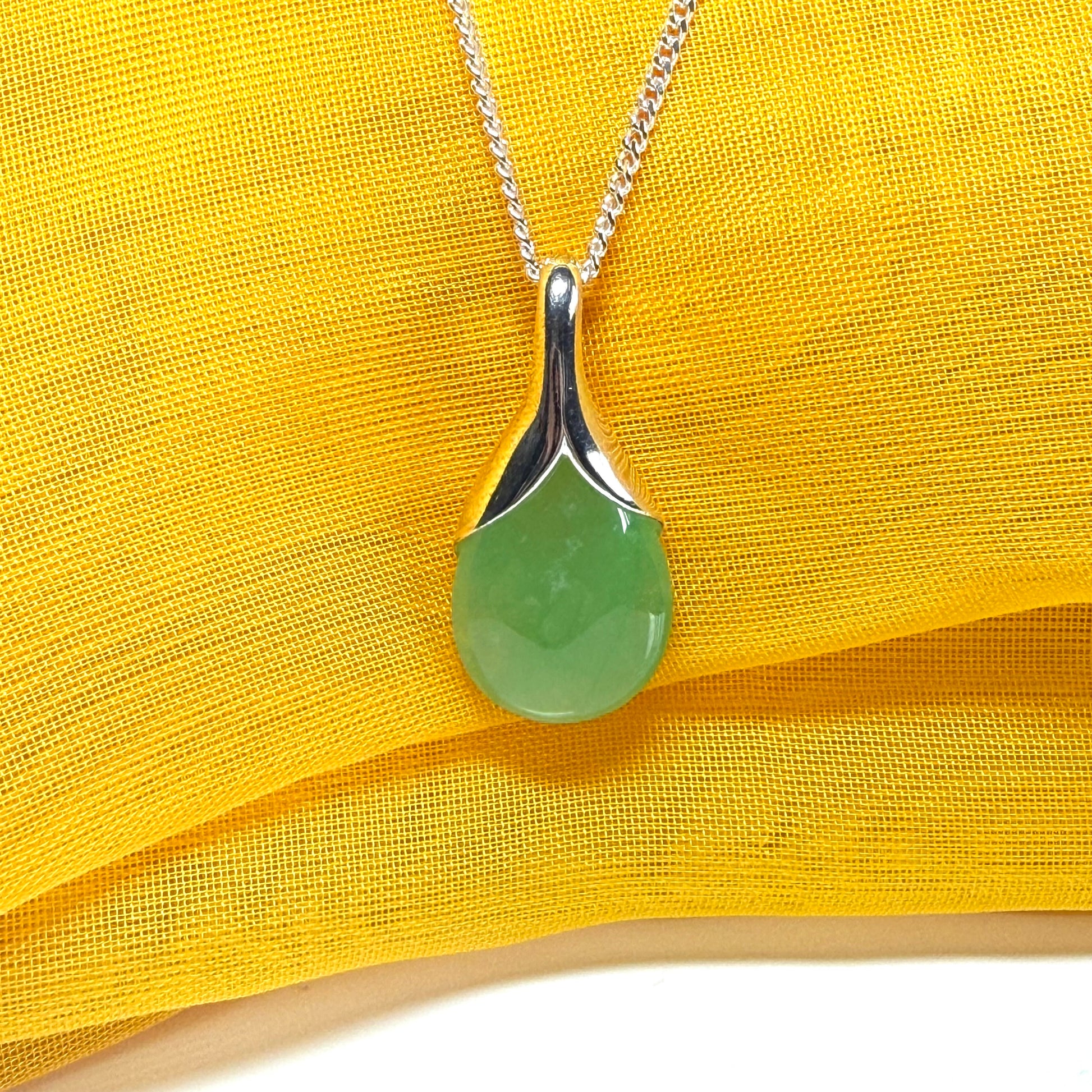 A stunning real green jade necklace in a teardrop, a timeless designed pendant and chain included