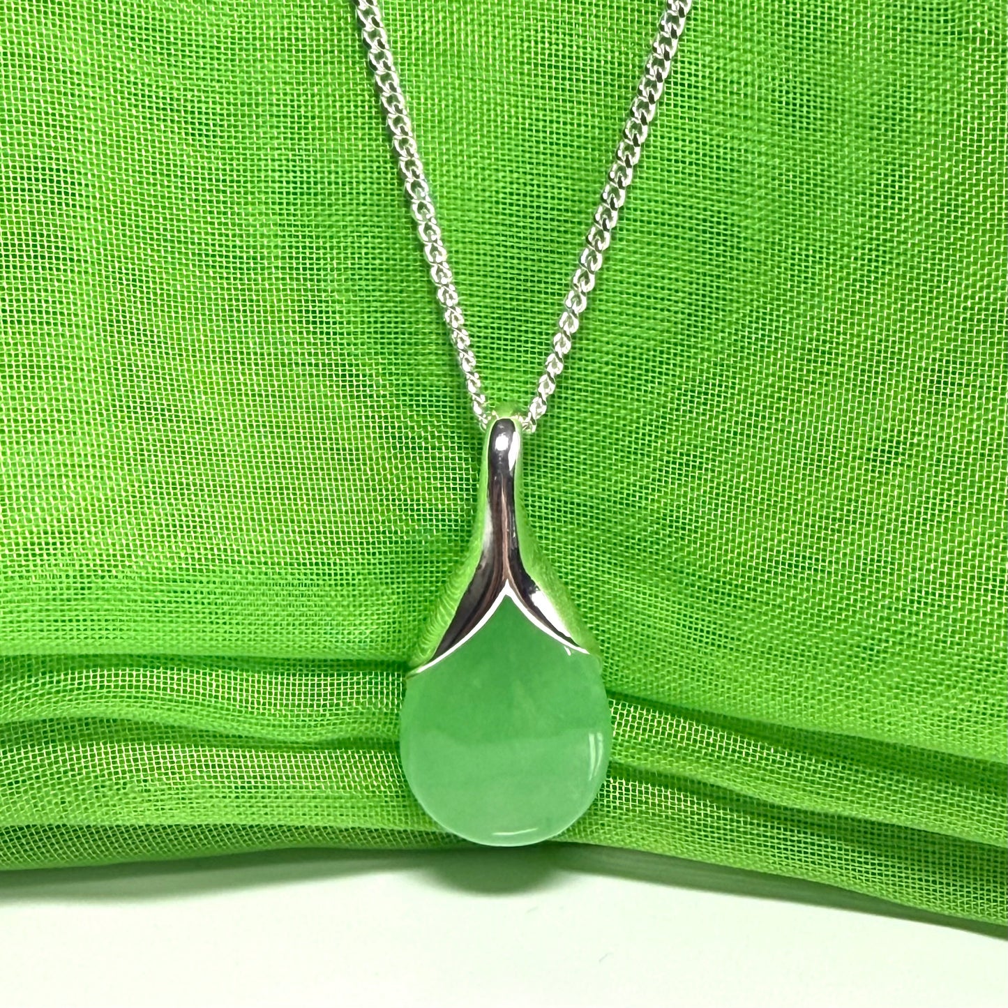 A stunning real green jade necklace in a teardrop, a timeless designed pendant and chain