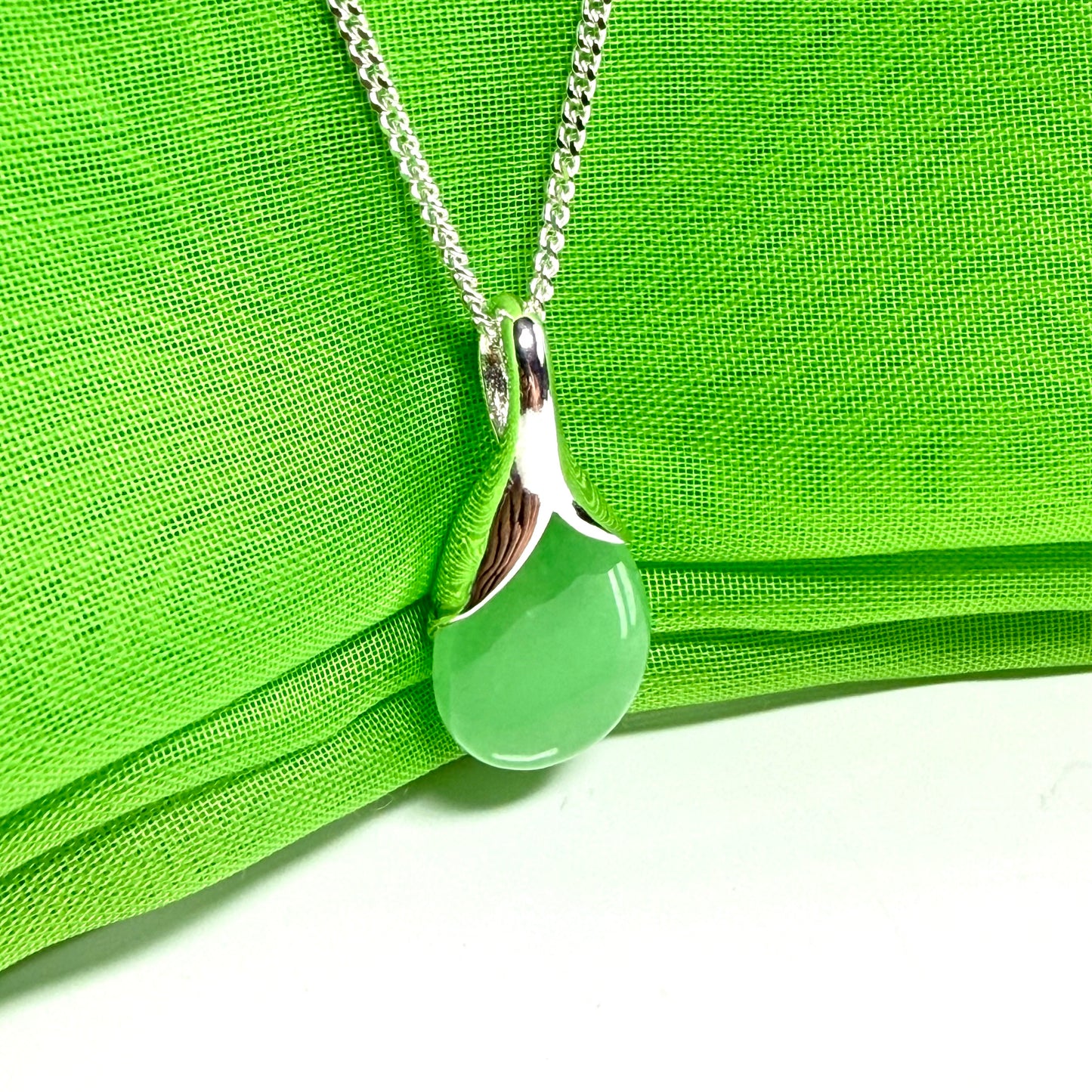 A stunning real green jade necklace in a teardrop, a timeless designed pendant and chain