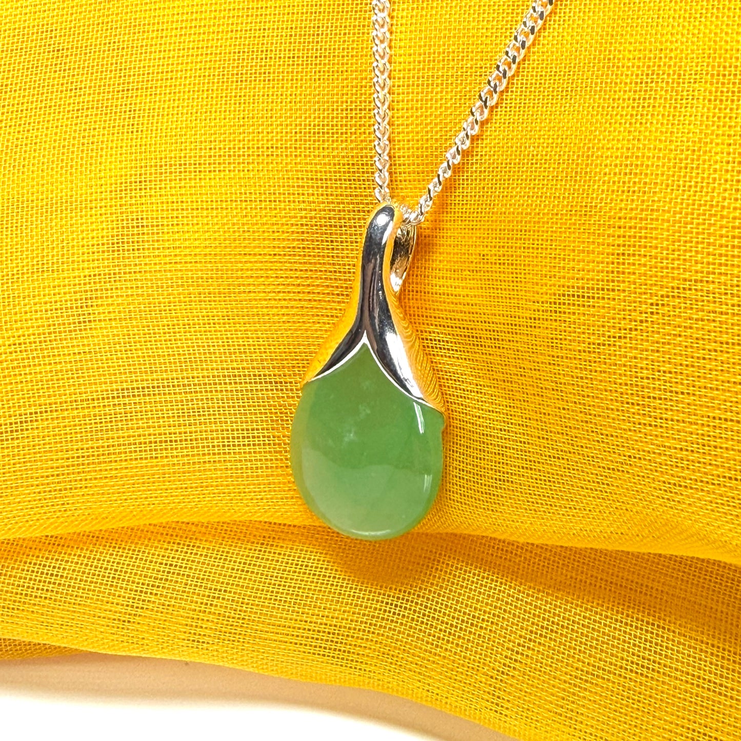 A stunning real green jade necklace in a teardrop, a timeless designed pendant and chain included