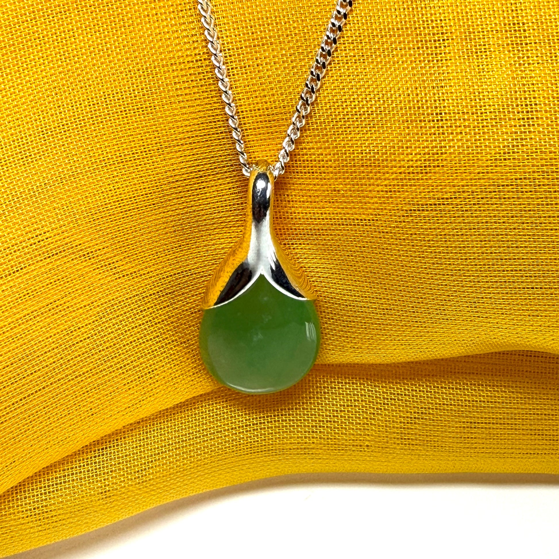 A stunning real green jade necklace in a teardrop, a timeless designed pendant and chain included