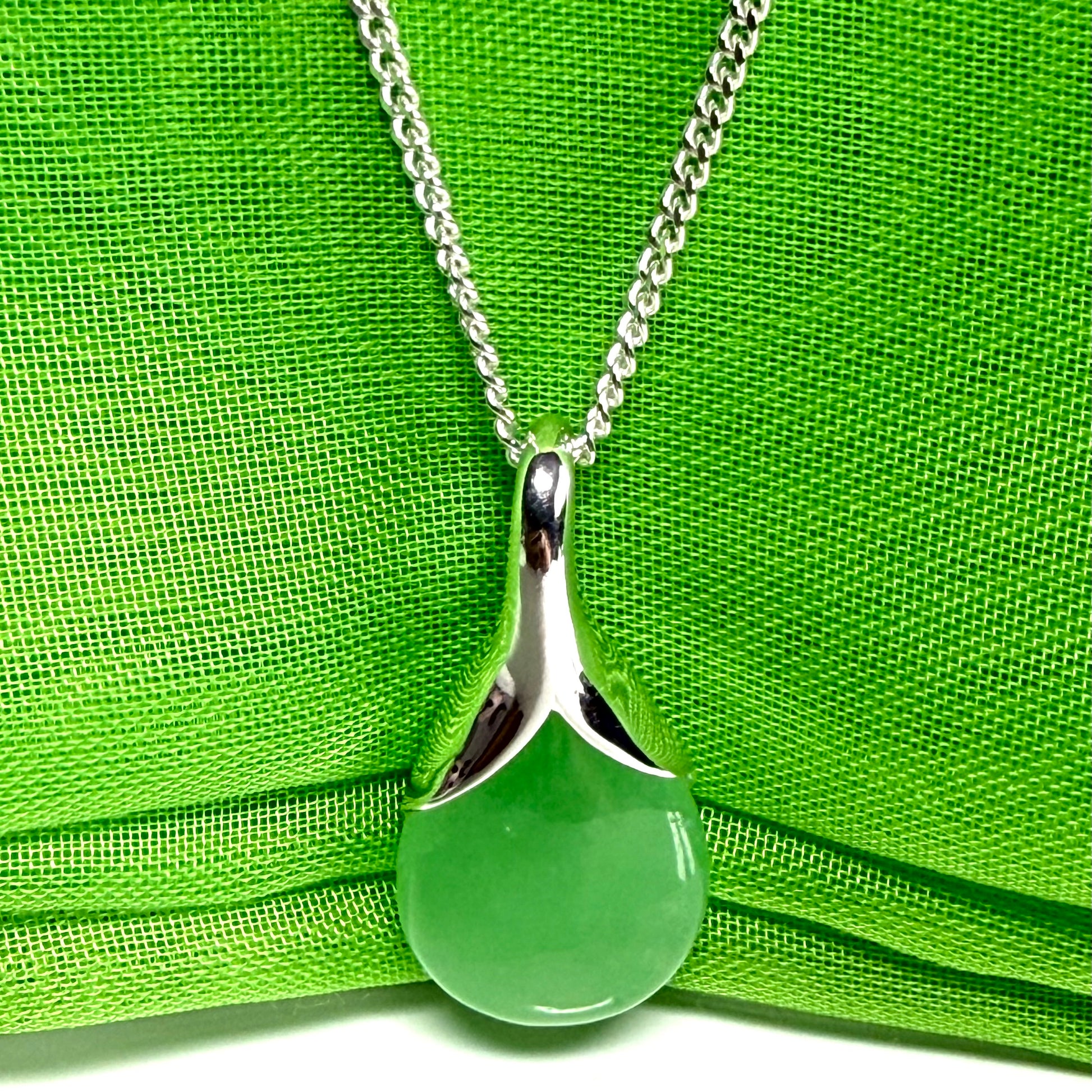 A stunning real green jade necklace in a teardrop, a timeless designed pendant and chain