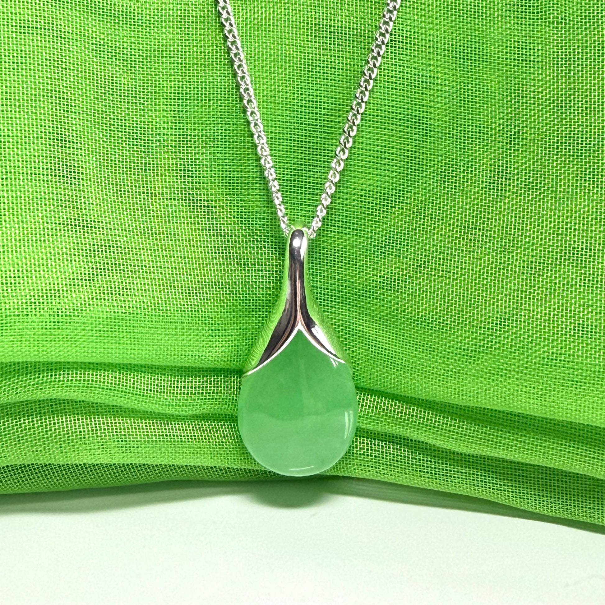 A stunning real green jade necklace in a teardrop, a timeless designed pendant and chain