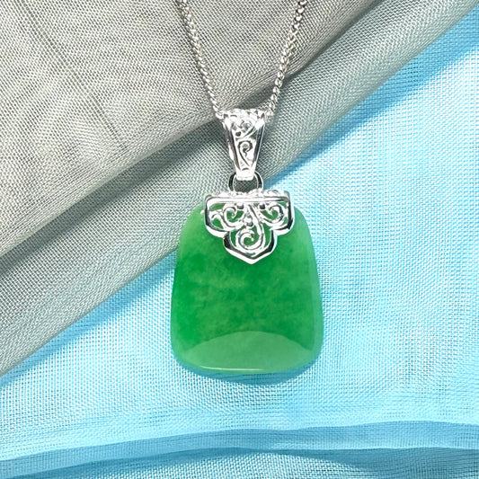 A stunning real green jade necklace with a large shaped and patterned pendant