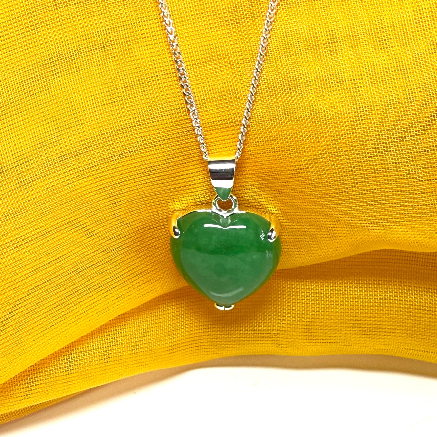 A stunning real green jade pendant heart shaped sterling silver, a traditional design necklace