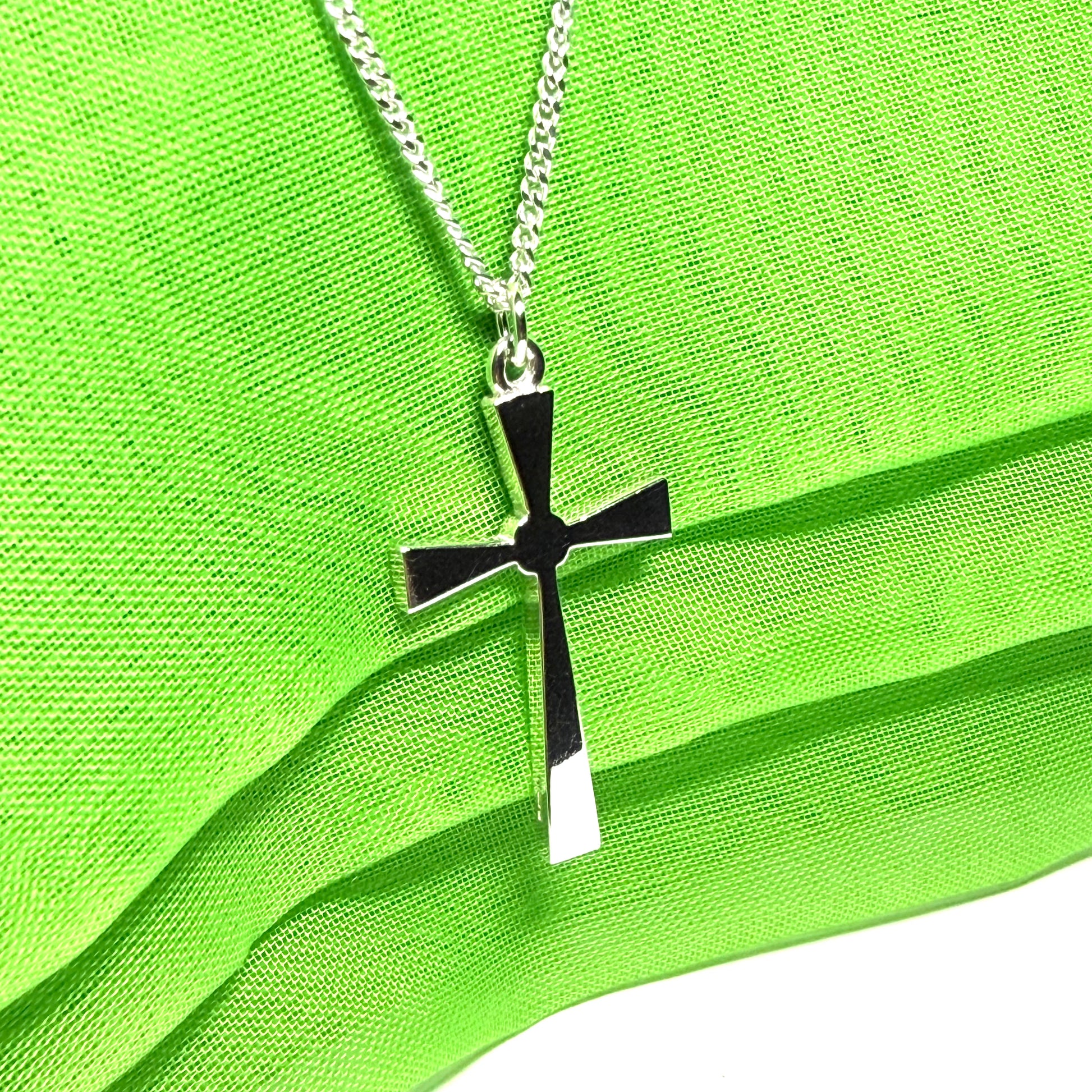 A thick solid sterling silver cross necklace fancy shaped pendant with a chain