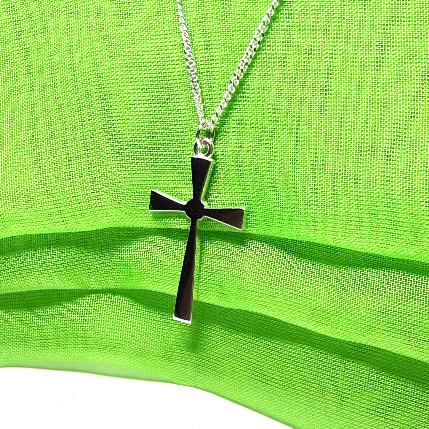 A thick solid sterling silver cross necklace fancy shaped pendant with a chain