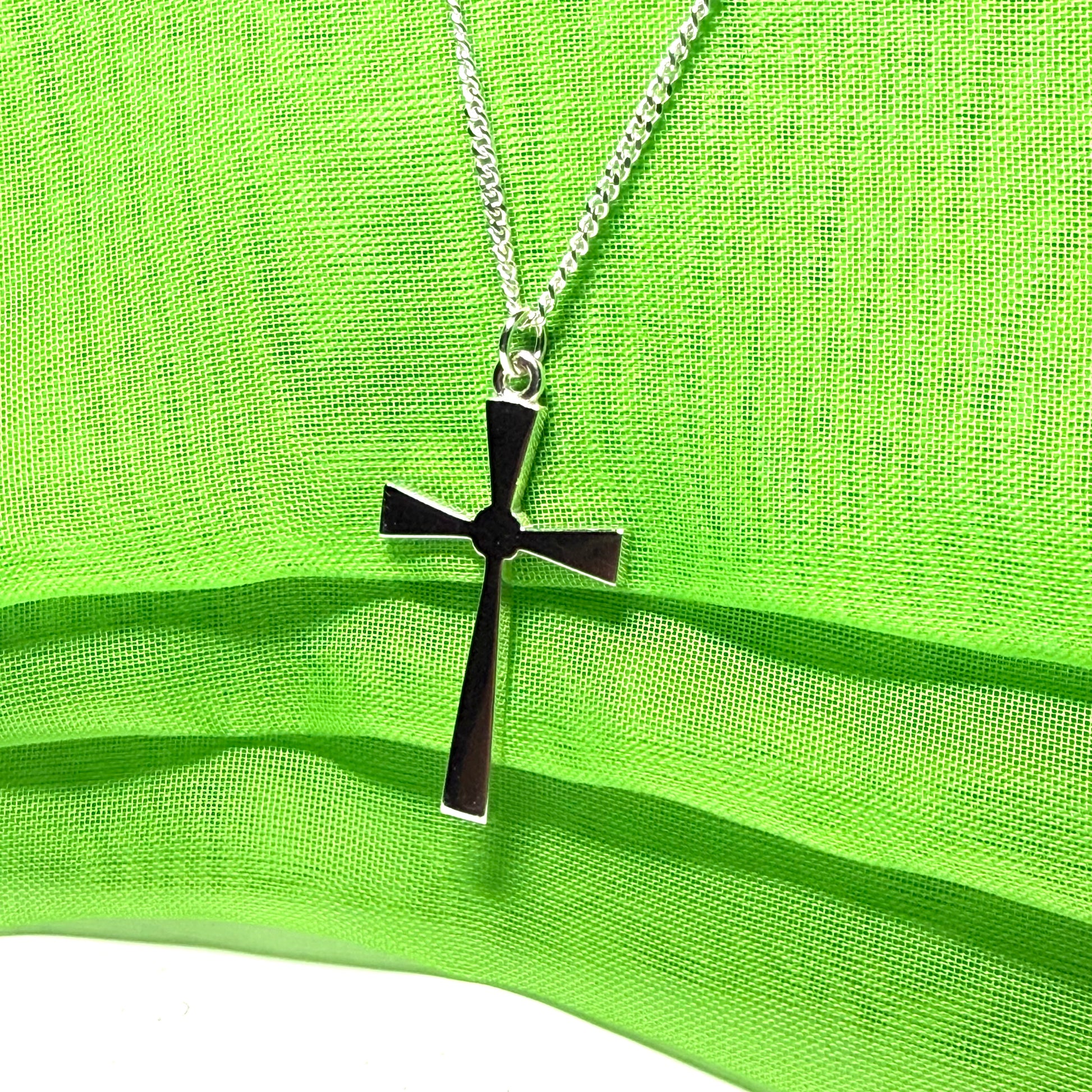 A thick solid sterling silver cross necklace fancy shaped pendant with a chain