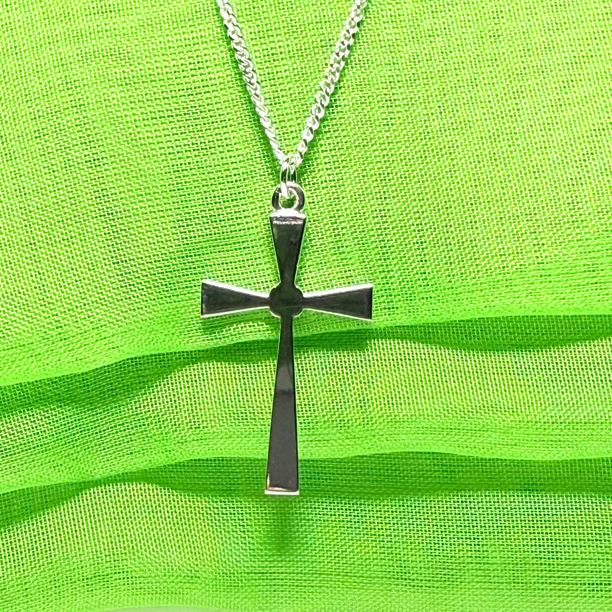 A thick solid sterling silver cross necklace fancy shaped pendant with a chain