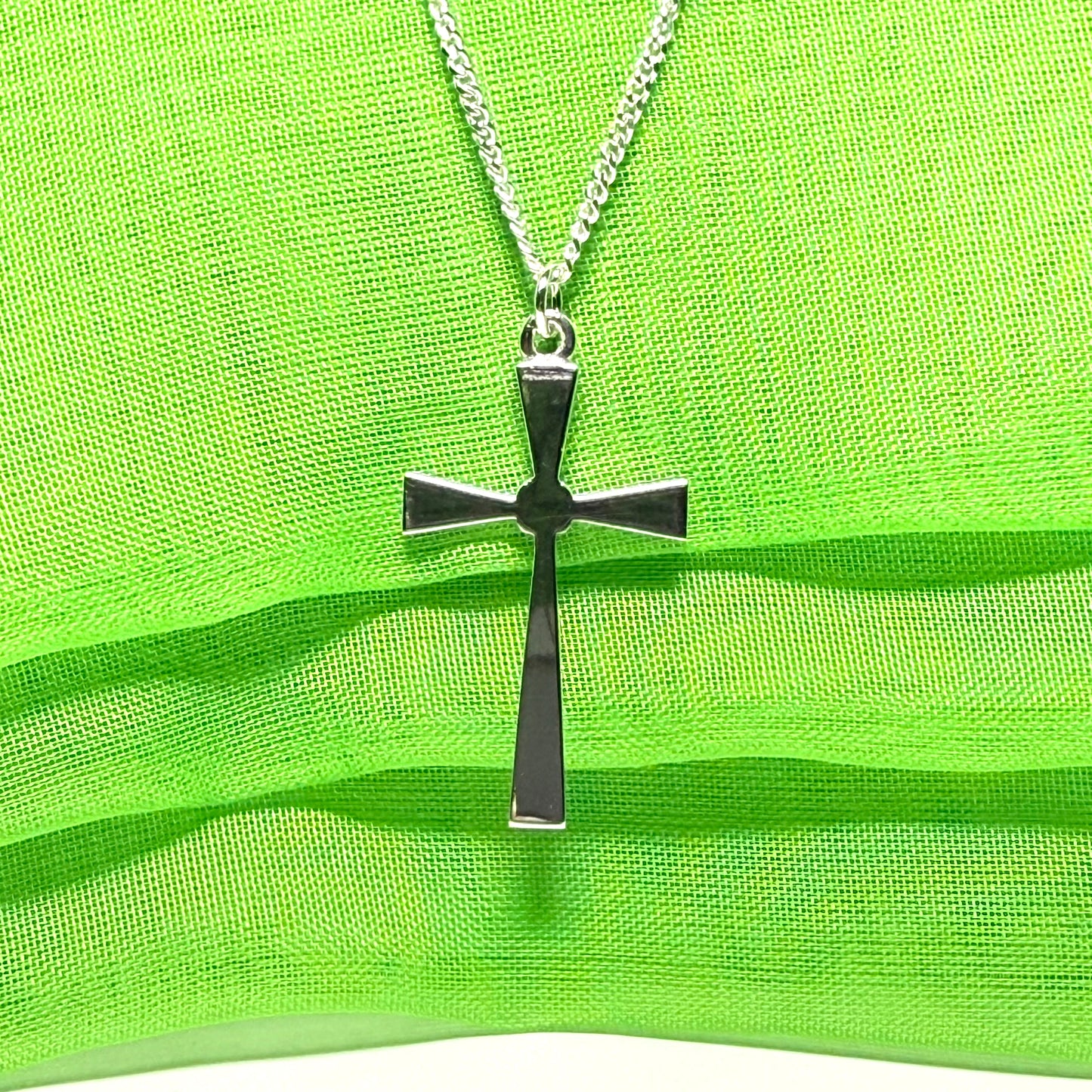A thick solid sterling silver cross necklace fancy shaped pendant with a chain