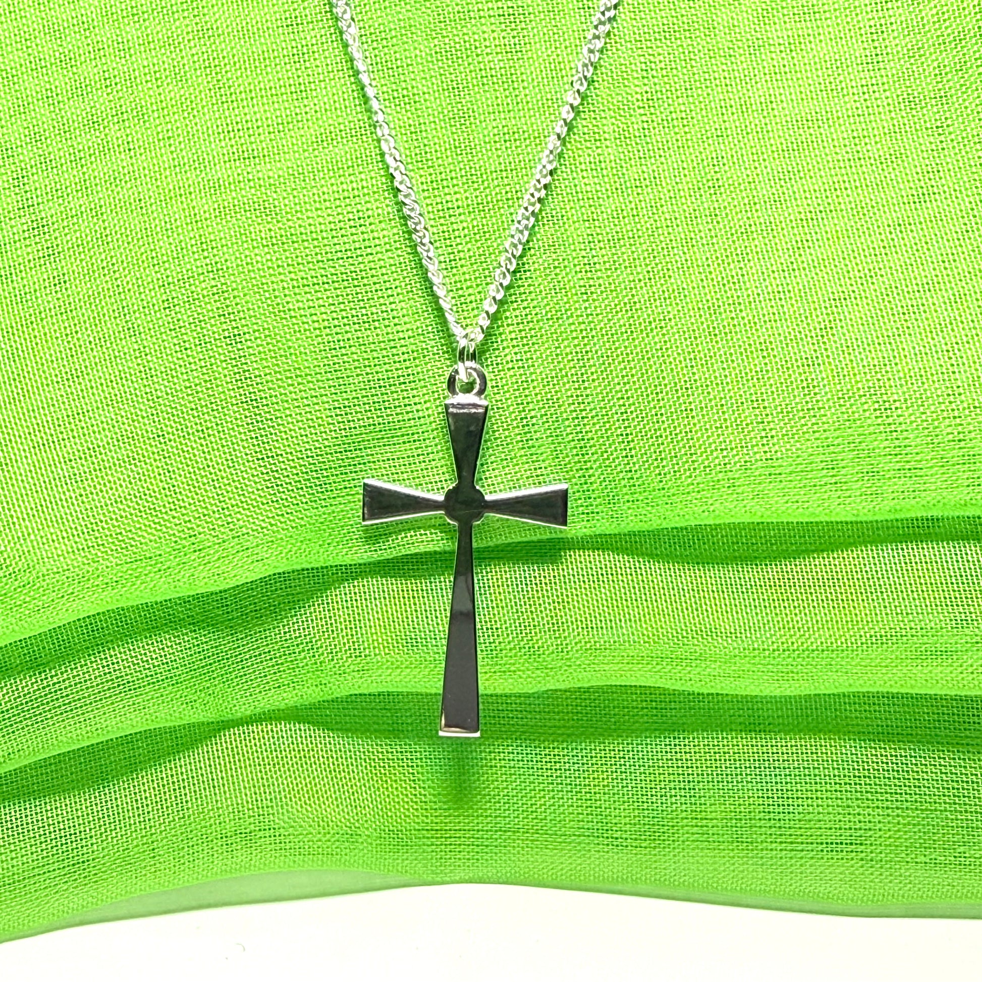 A thick solid sterling silver cross necklace fancy shaped pendant with a chain