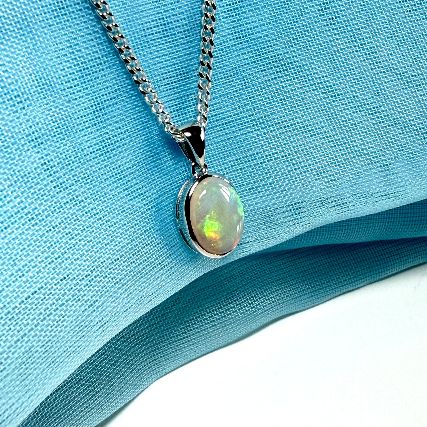 White gold real oval opal pendant rubbed over necklace with chain