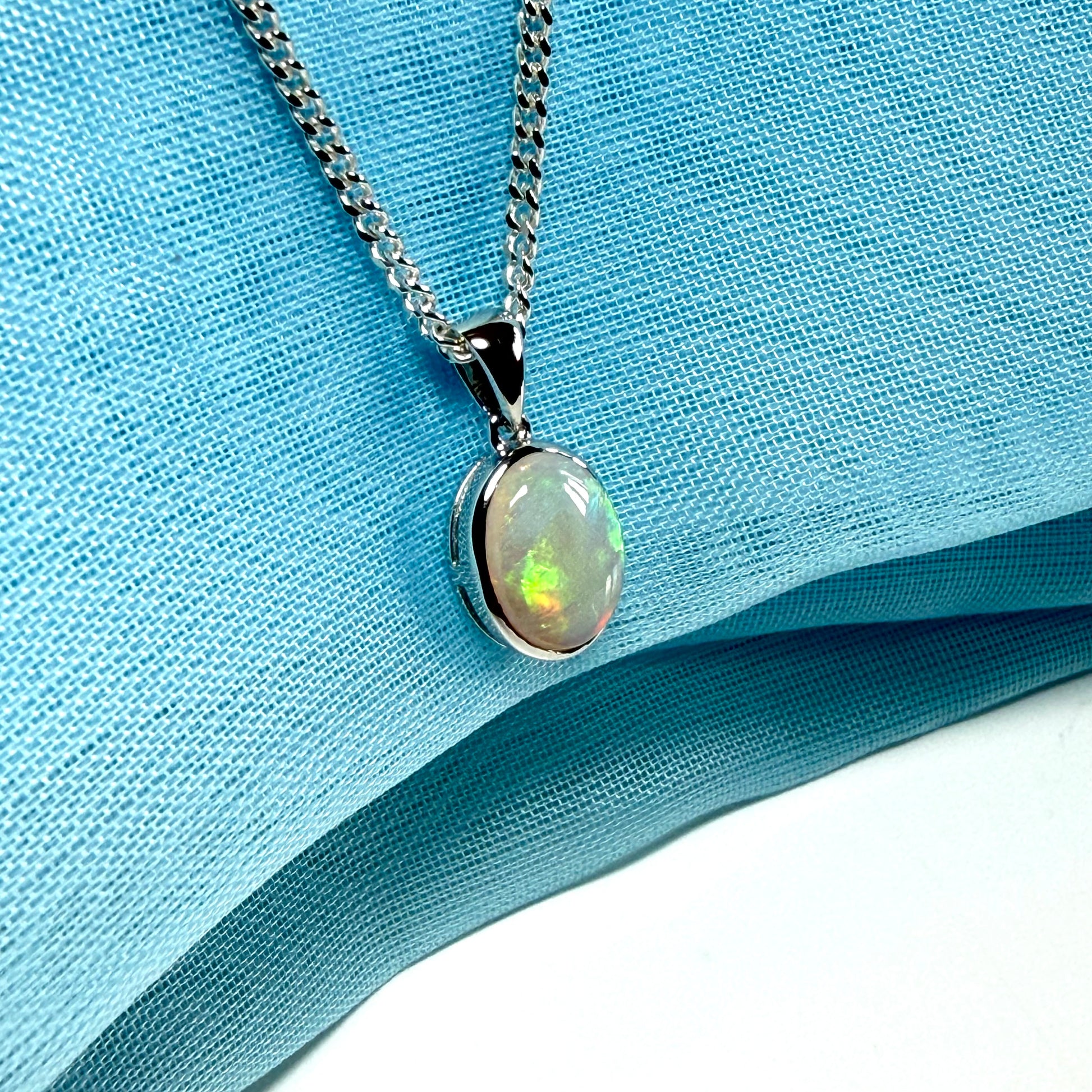 White gold real oval opal pendant rubbed over necklace with chain