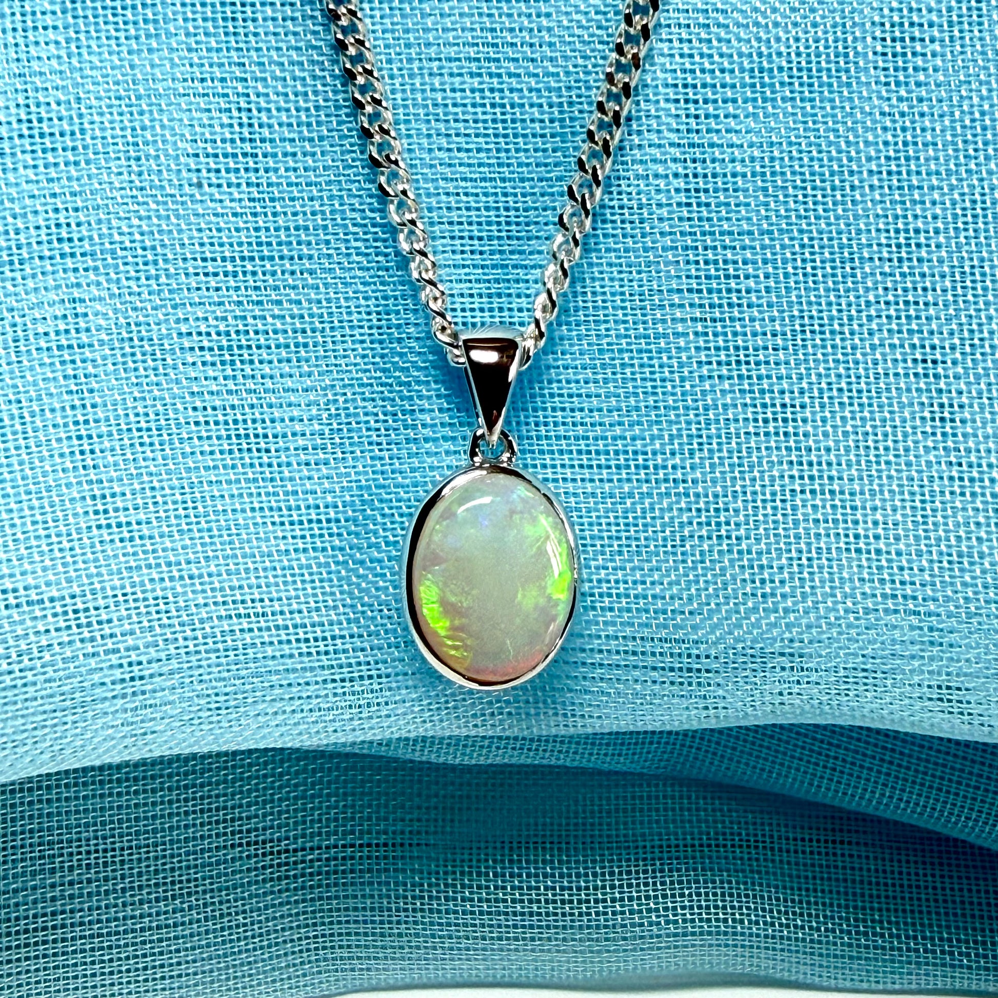 White gold real oval opal pendant rubbed over necklace with chain