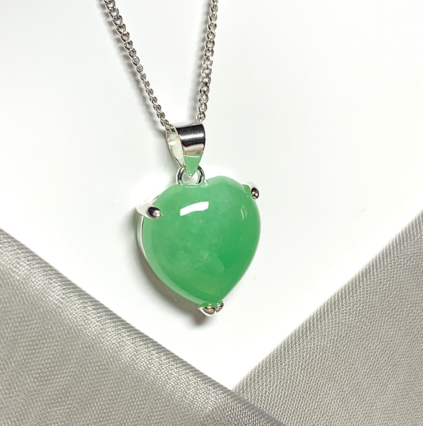 A beautiful and stunning real green jade necklace heart shaped sterling silver pendant