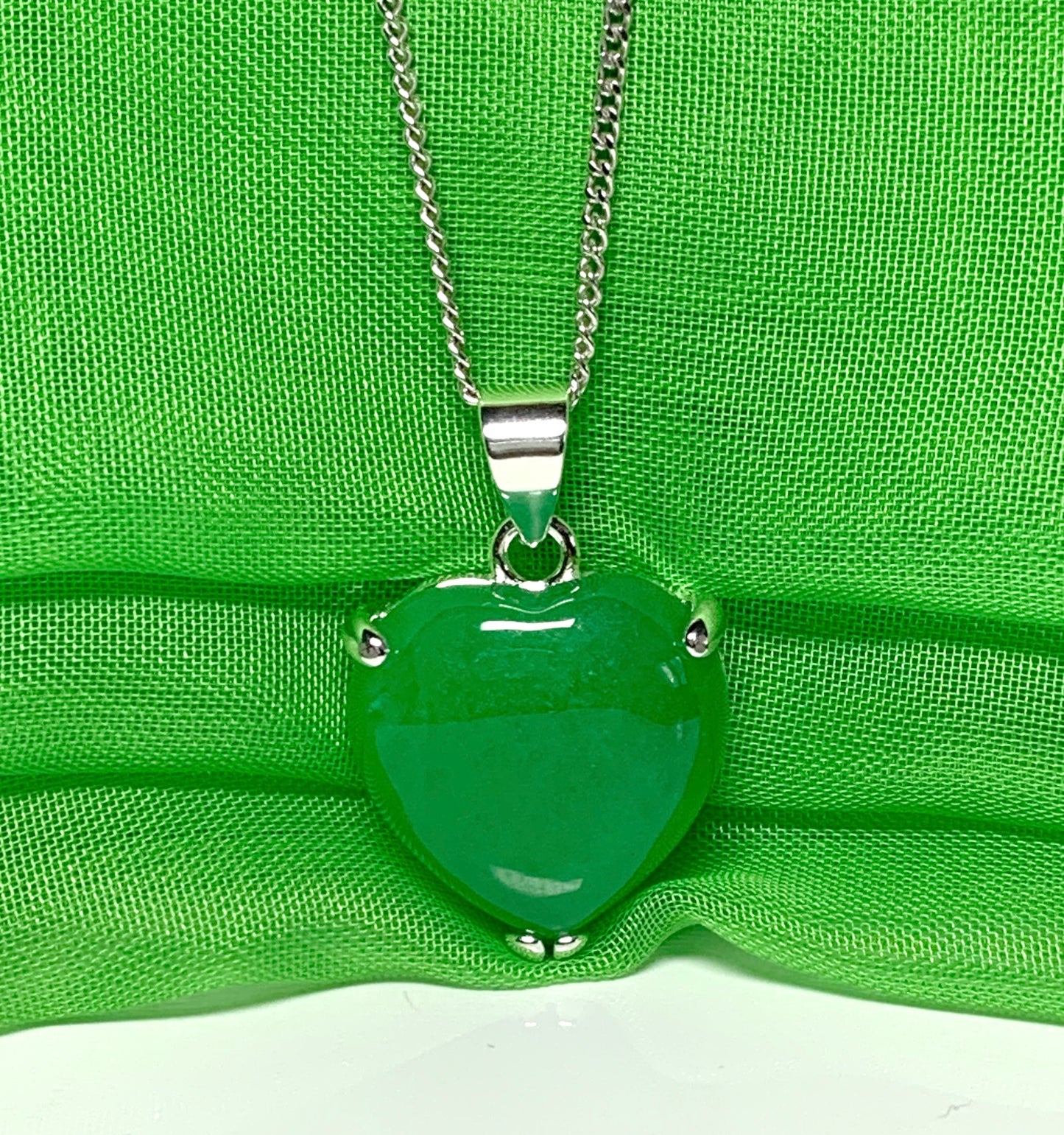 A beautiful real green jade necklace heart shape sterling silver pendant