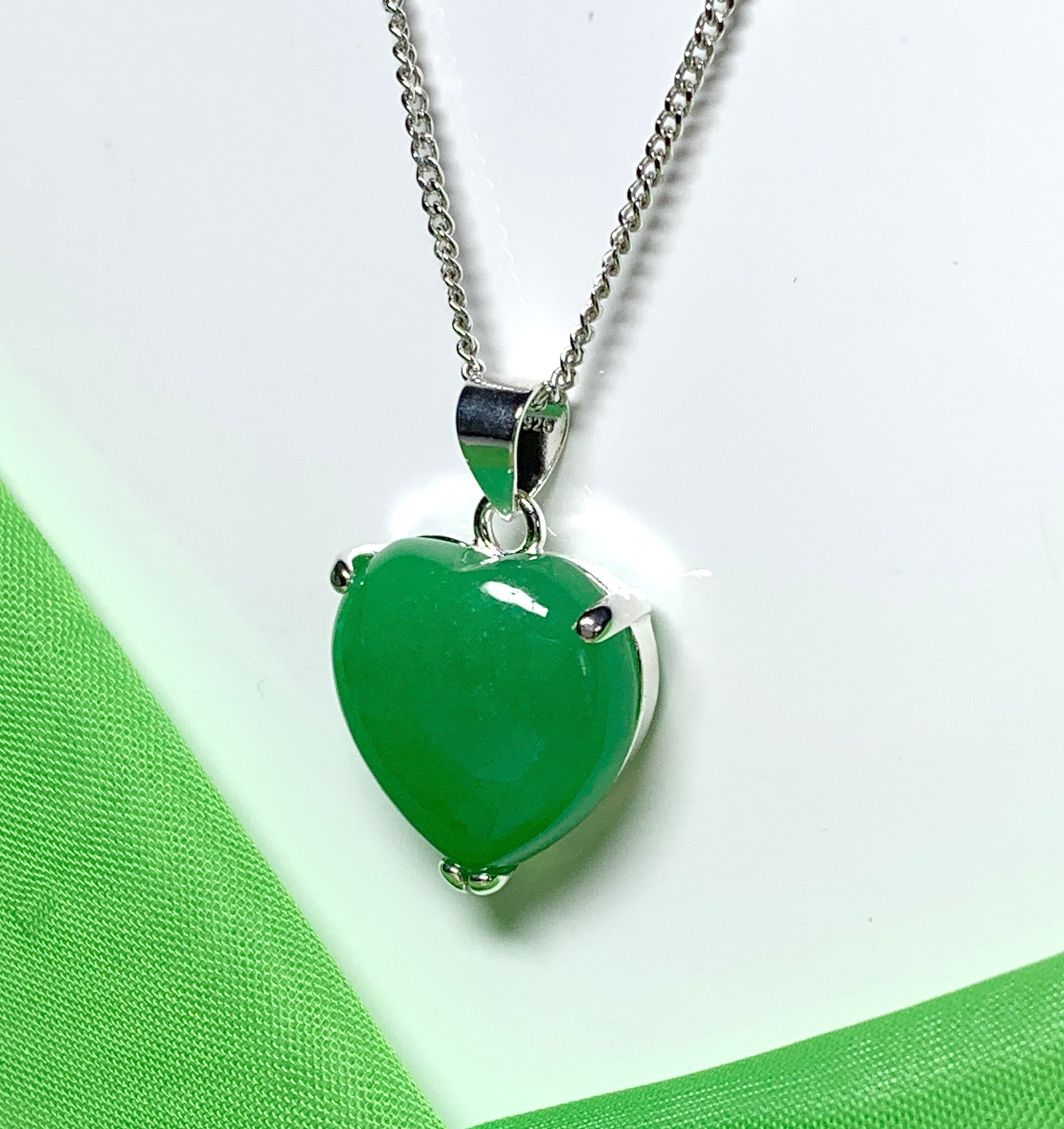 A beautiful real green jade necklace heart shape sterling silver pendant