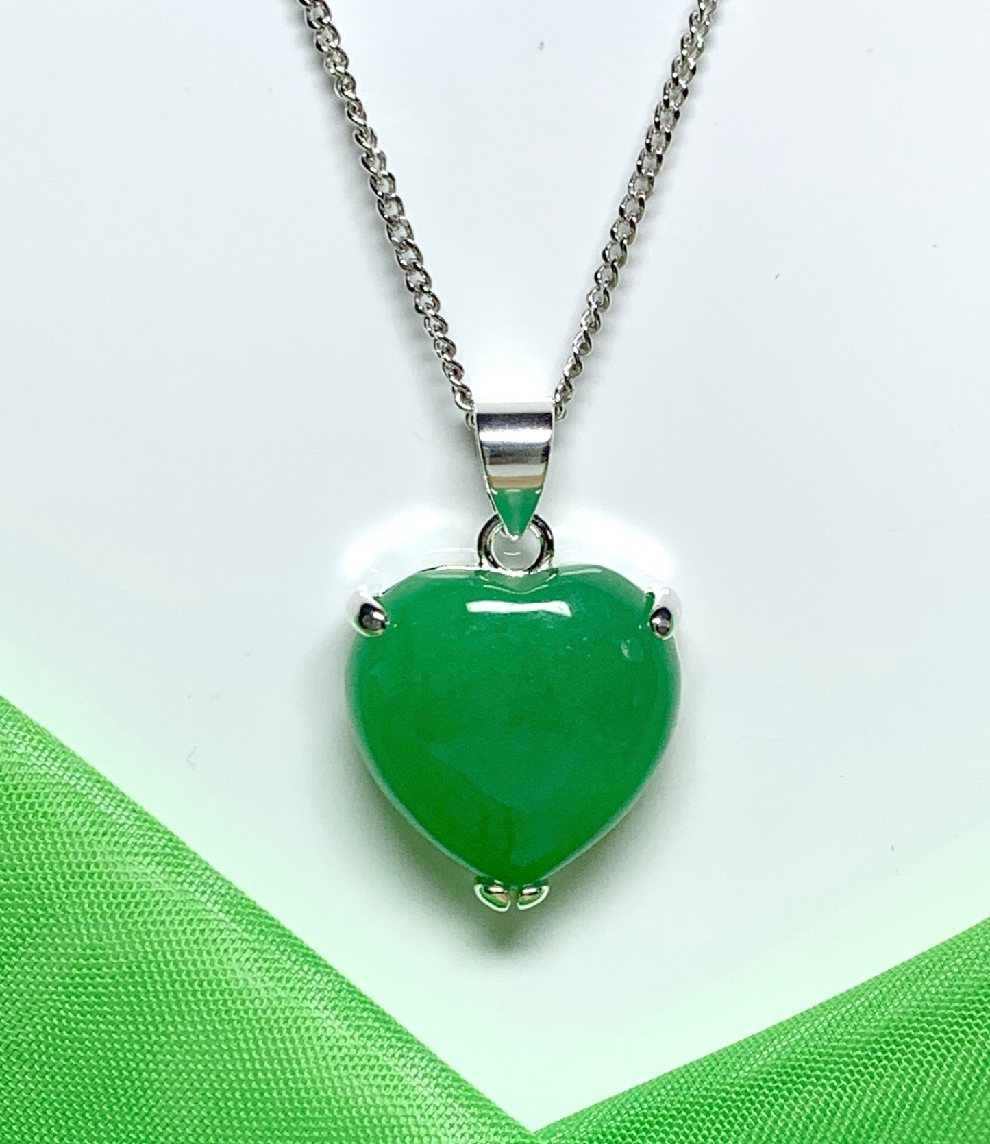 A beautiful real green jade necklace heart shape sterling silver pendant