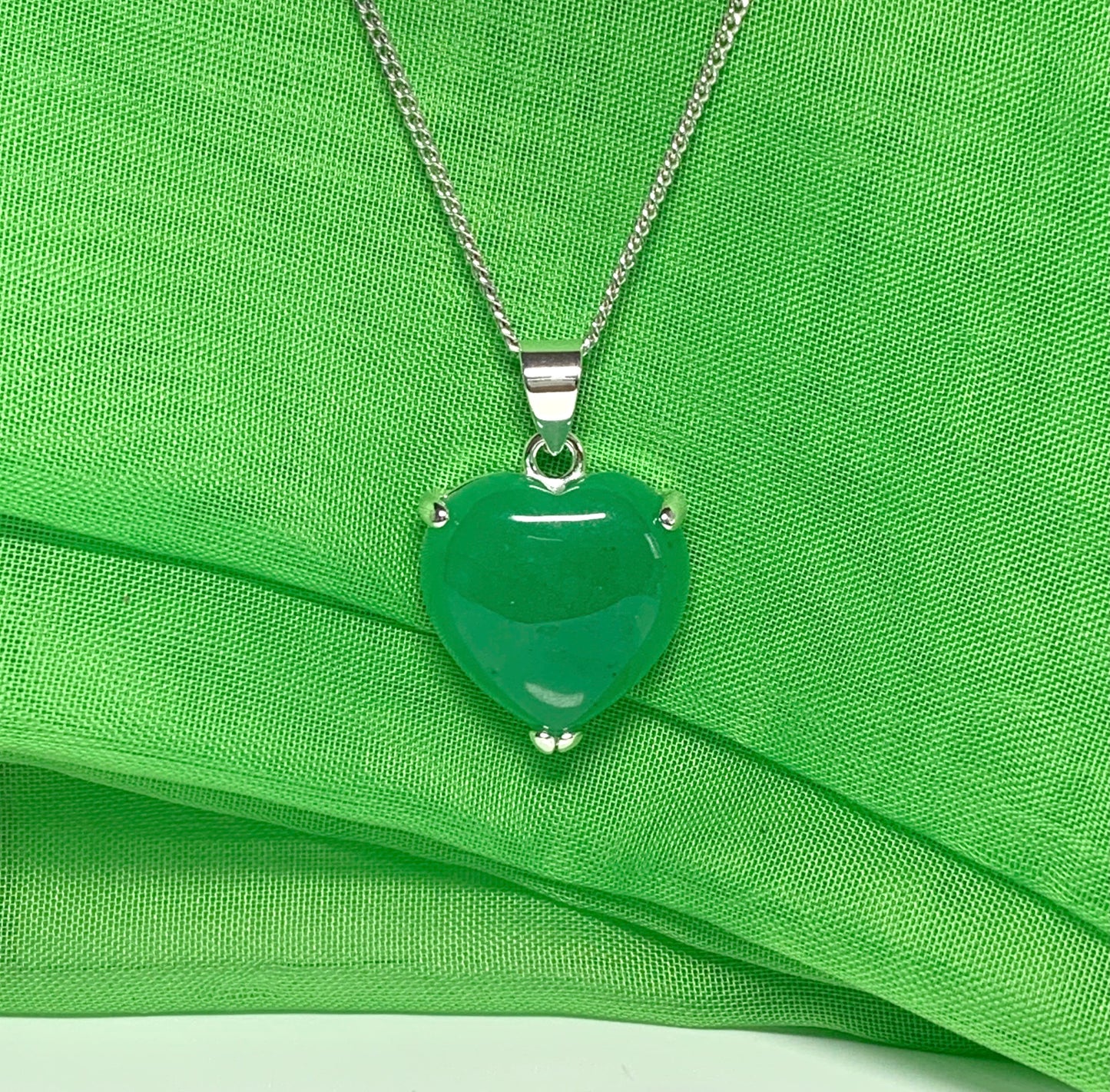 A gorgeous real green jade necklace heart shape sterling silver pendant