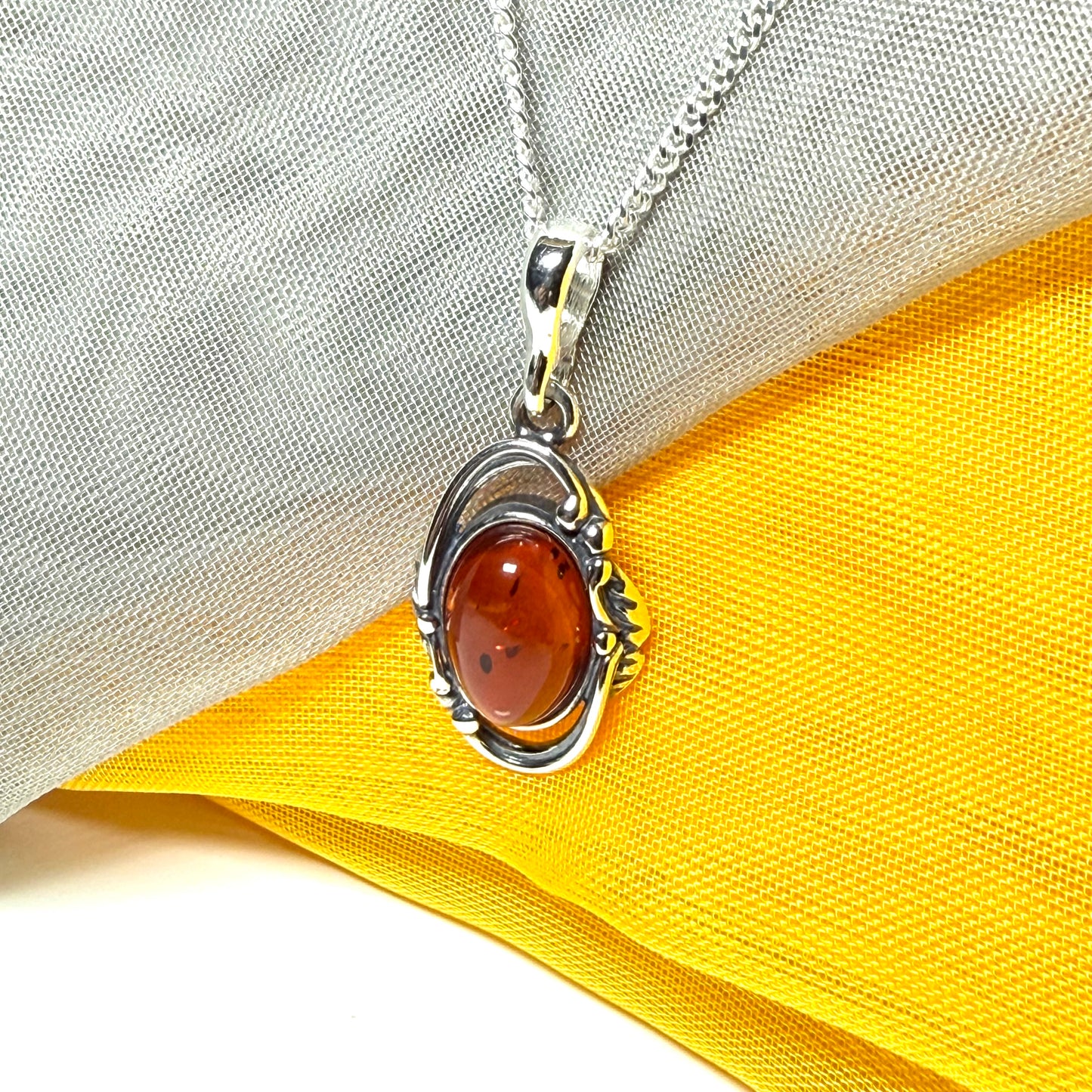 Orange real amber oval sterling silver necklace with a swirl set open pendant With chain