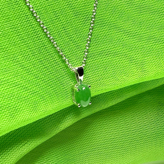 An oval shaped real green jade necklace white gold including chain