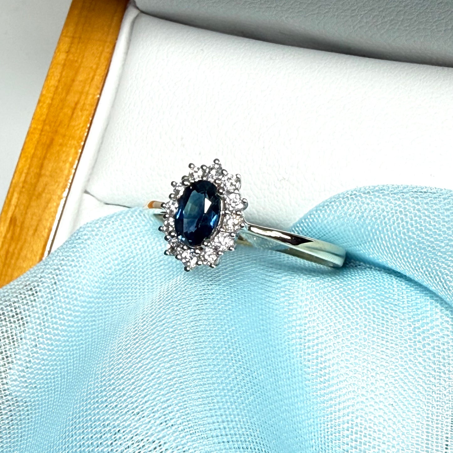 An oval shaped Blue Real Sapphire and Diamond White Gold Cluster Ring