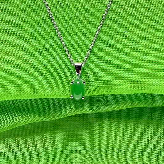 An oval shaped real green jade necklace white gold including chain