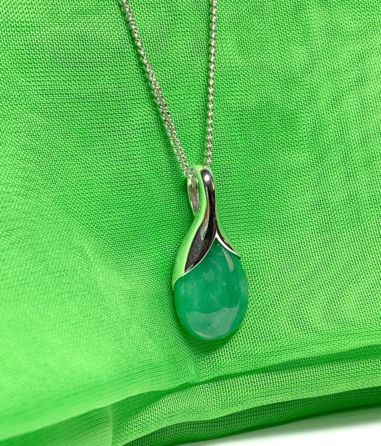 A real green jade necklace in a tear drop or pear shape pendant