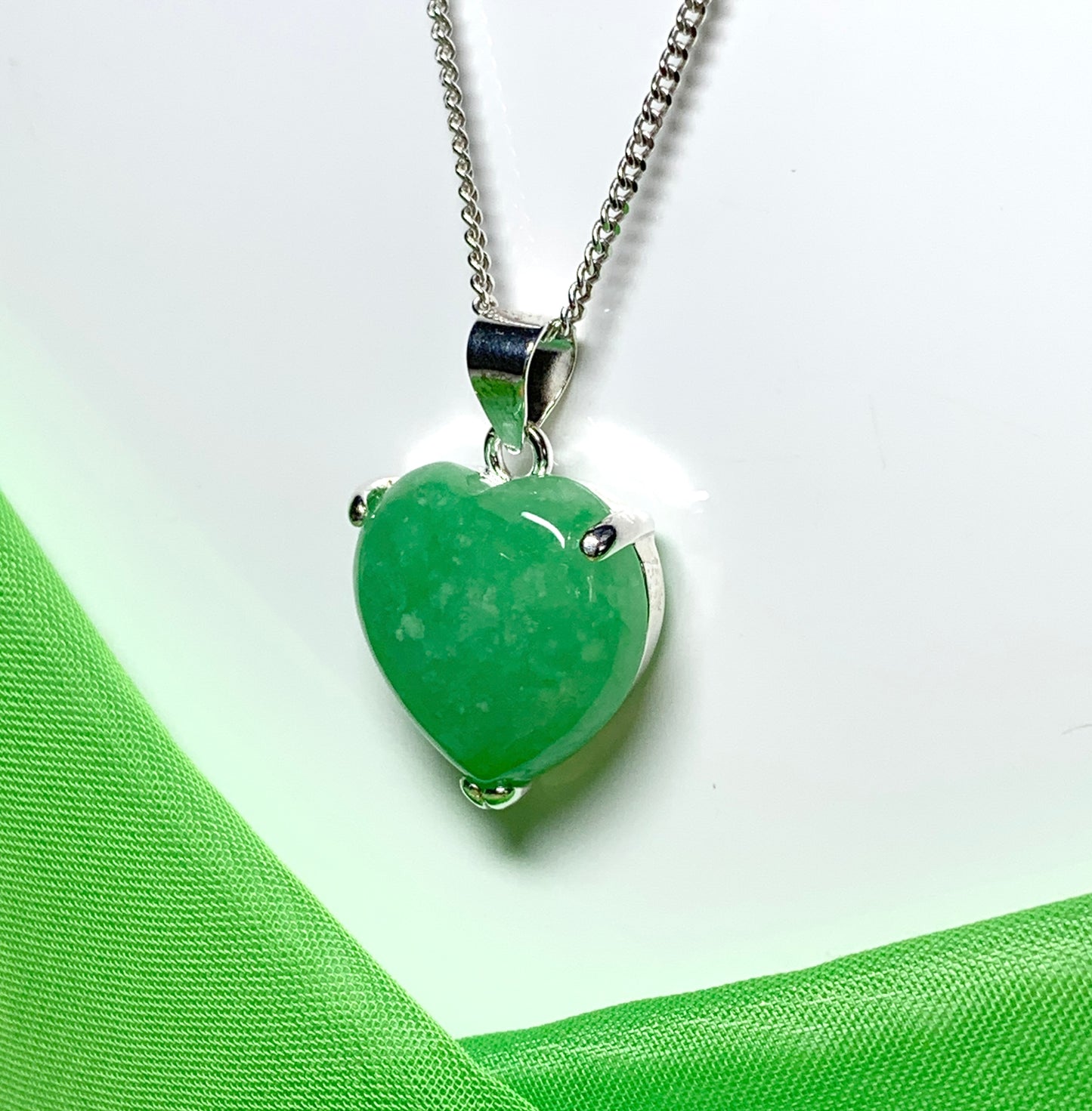 A real green jade necklace heart shape sterling silver pendant