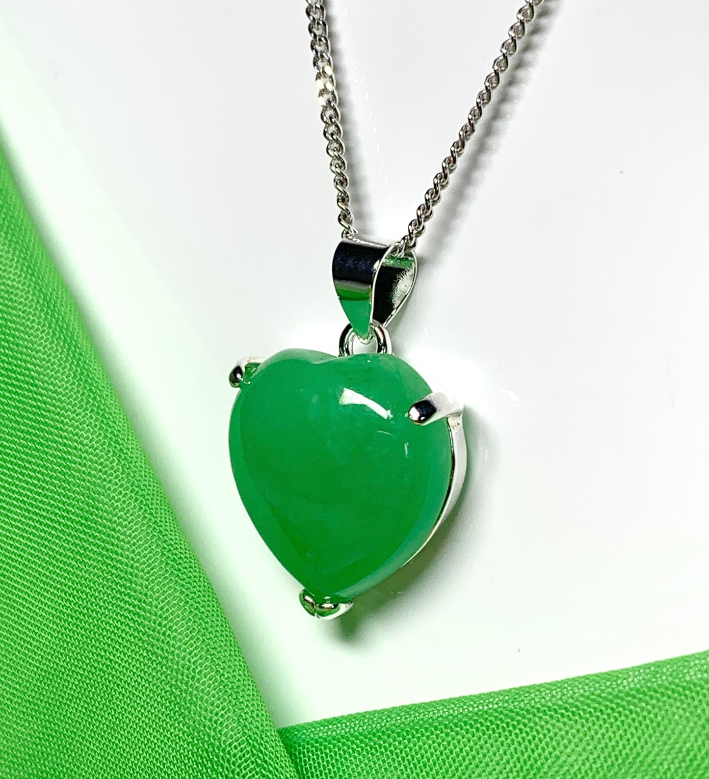 A real green jade necklace heart shape sterling silver pendant including chain