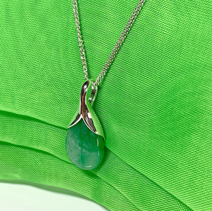 A real green jade necklace in a teardrop or pear shaped