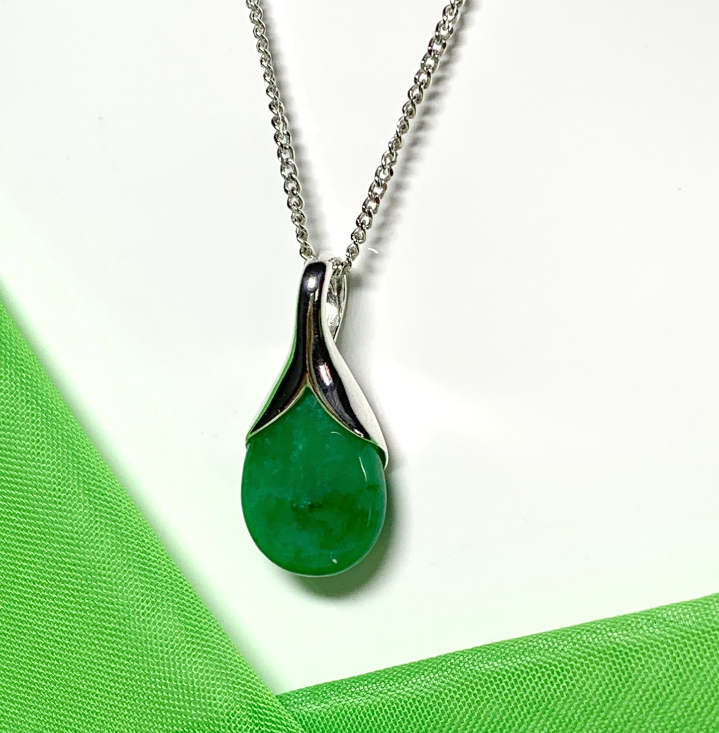 A real green jade necklace in a tear drop or pear shape pendant