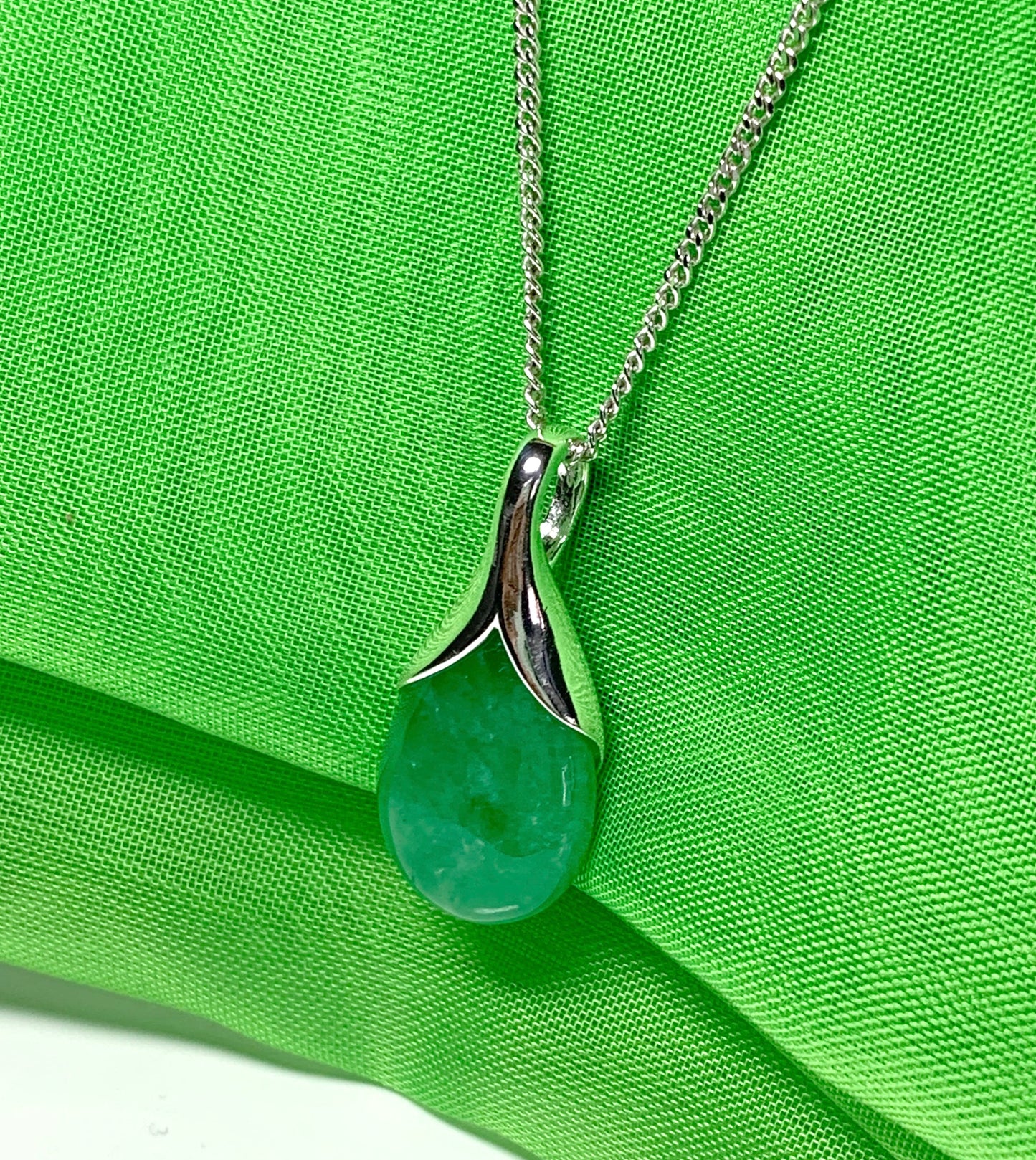 A real green jade necklace in a tear drop or pear shape