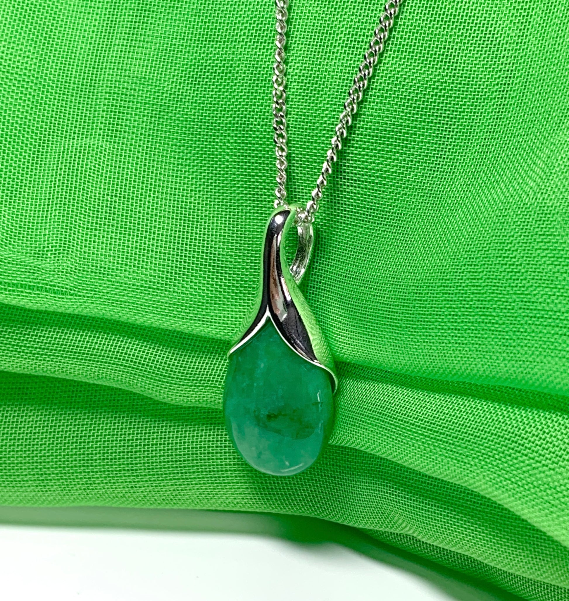 A real green jade necklace in a tear drop or pear shape pendant