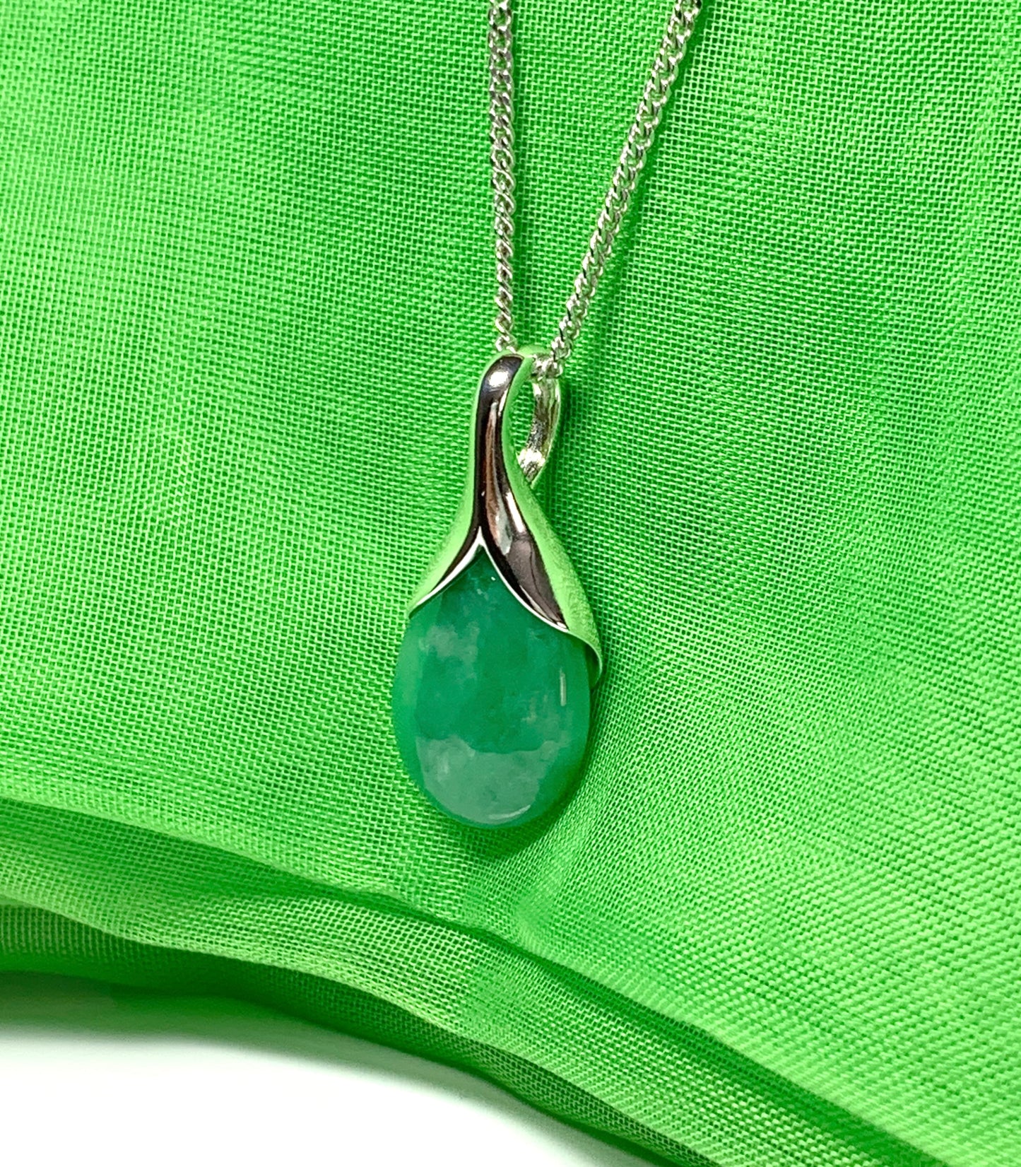 A real green jade necklace in a tear drop or pear shape pendant