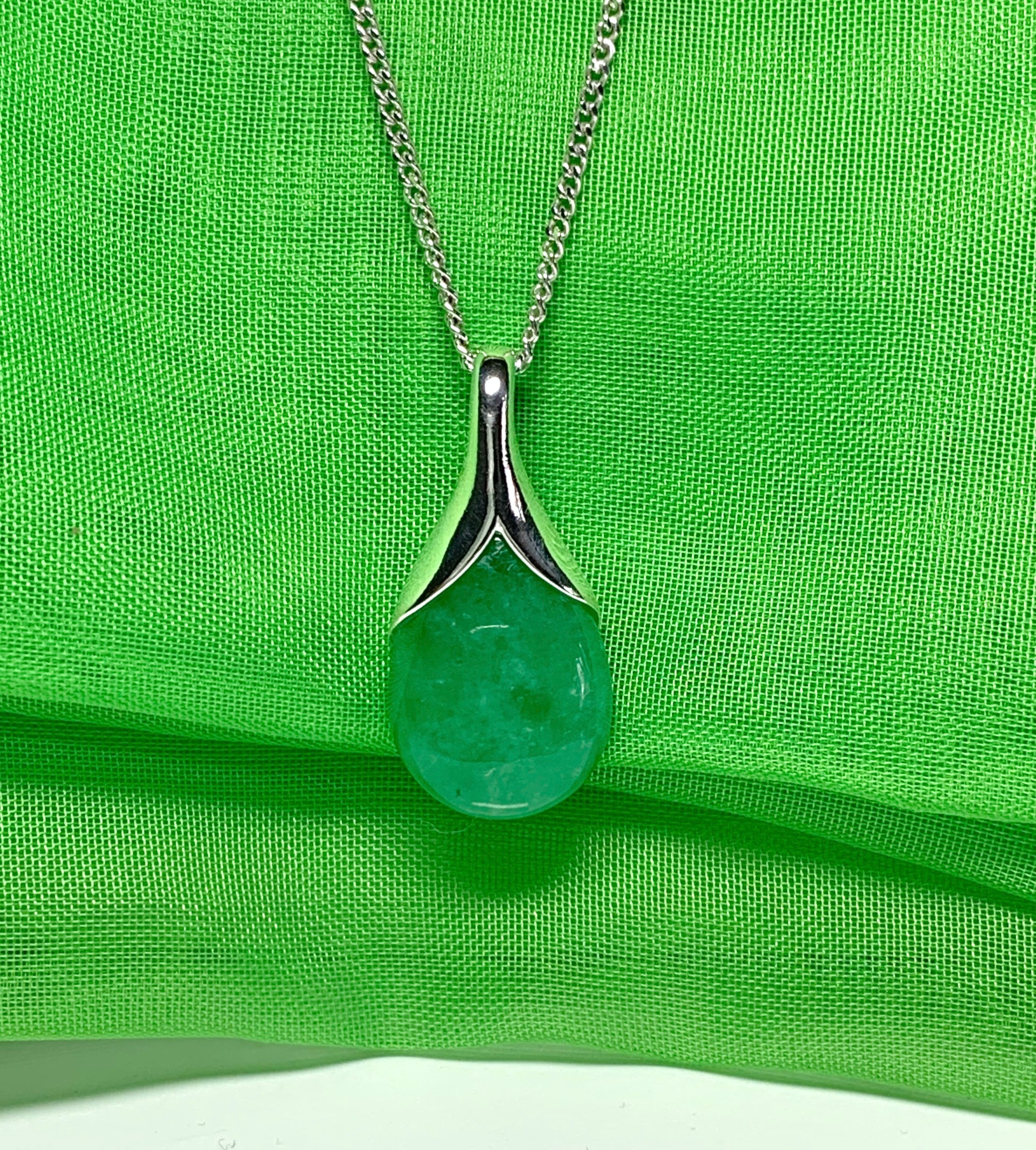 A real green jade necklace in a tear drop or pear shape