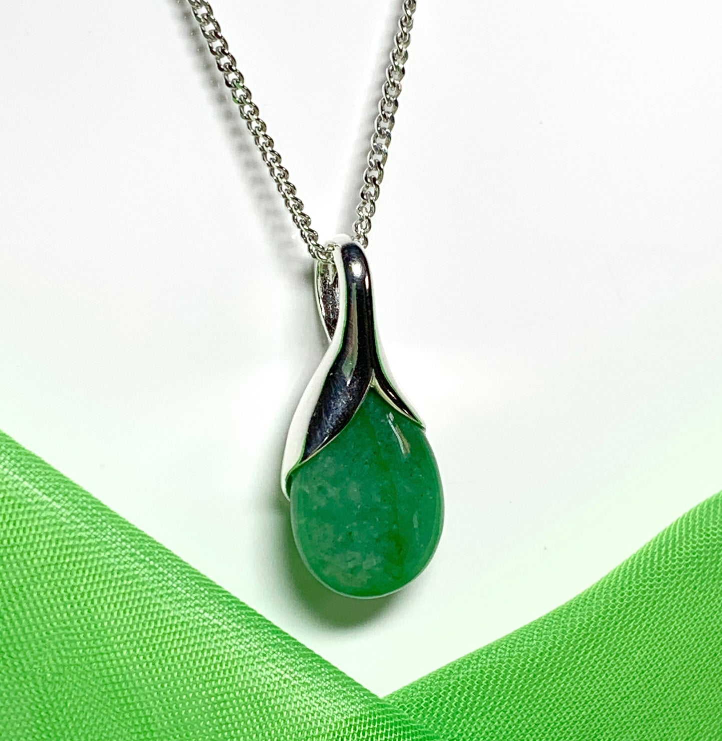 A real green jade necklace in a teardrop or pear shaped