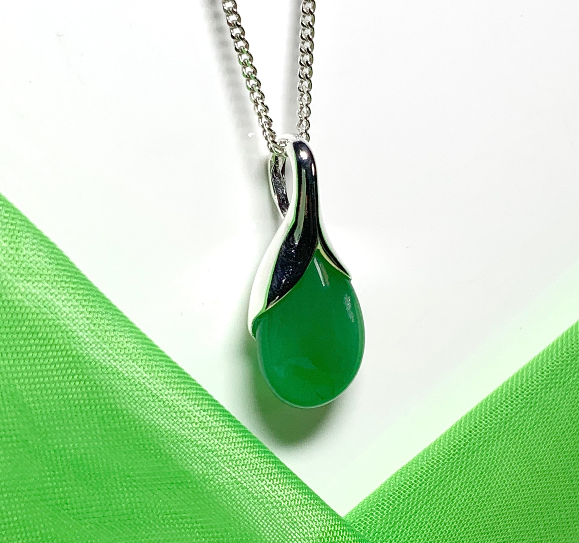 A real green jade necklace in a tear drop or pear shaped