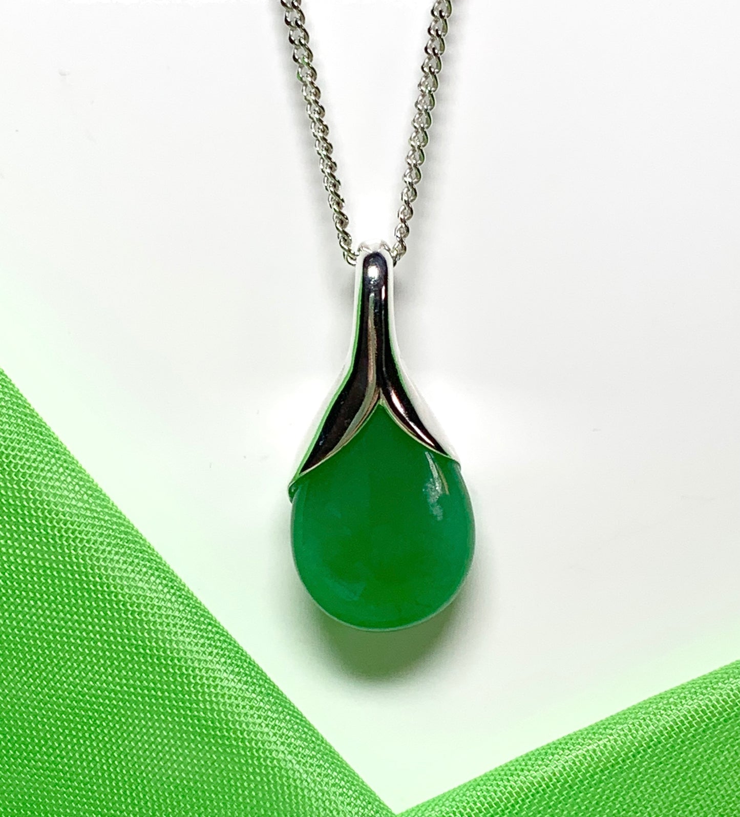 A real green jade necklace in a tear drop or pear shaped