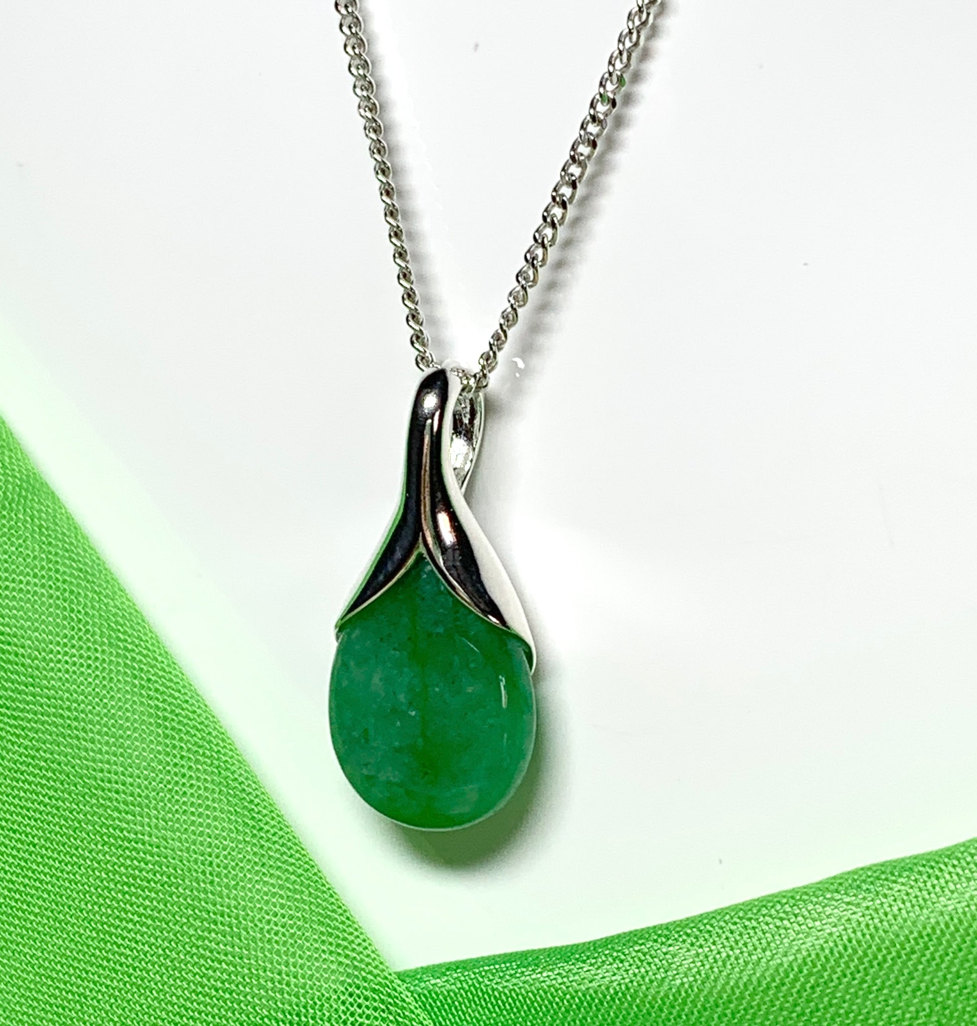 A real green jade necklace in a teardrop or pear shaped