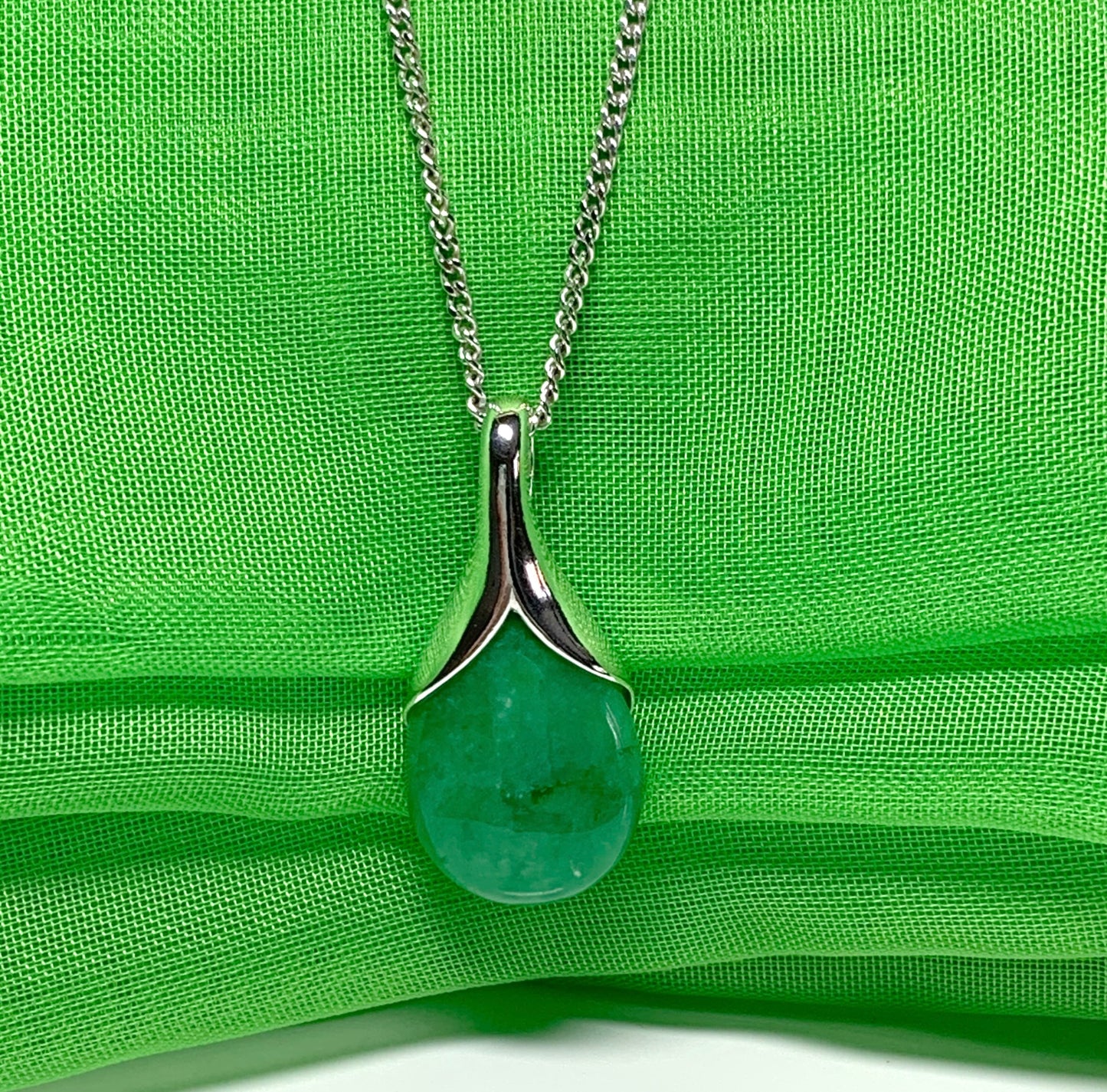 A real green jade necklace in a tear drop or pear shape pendant