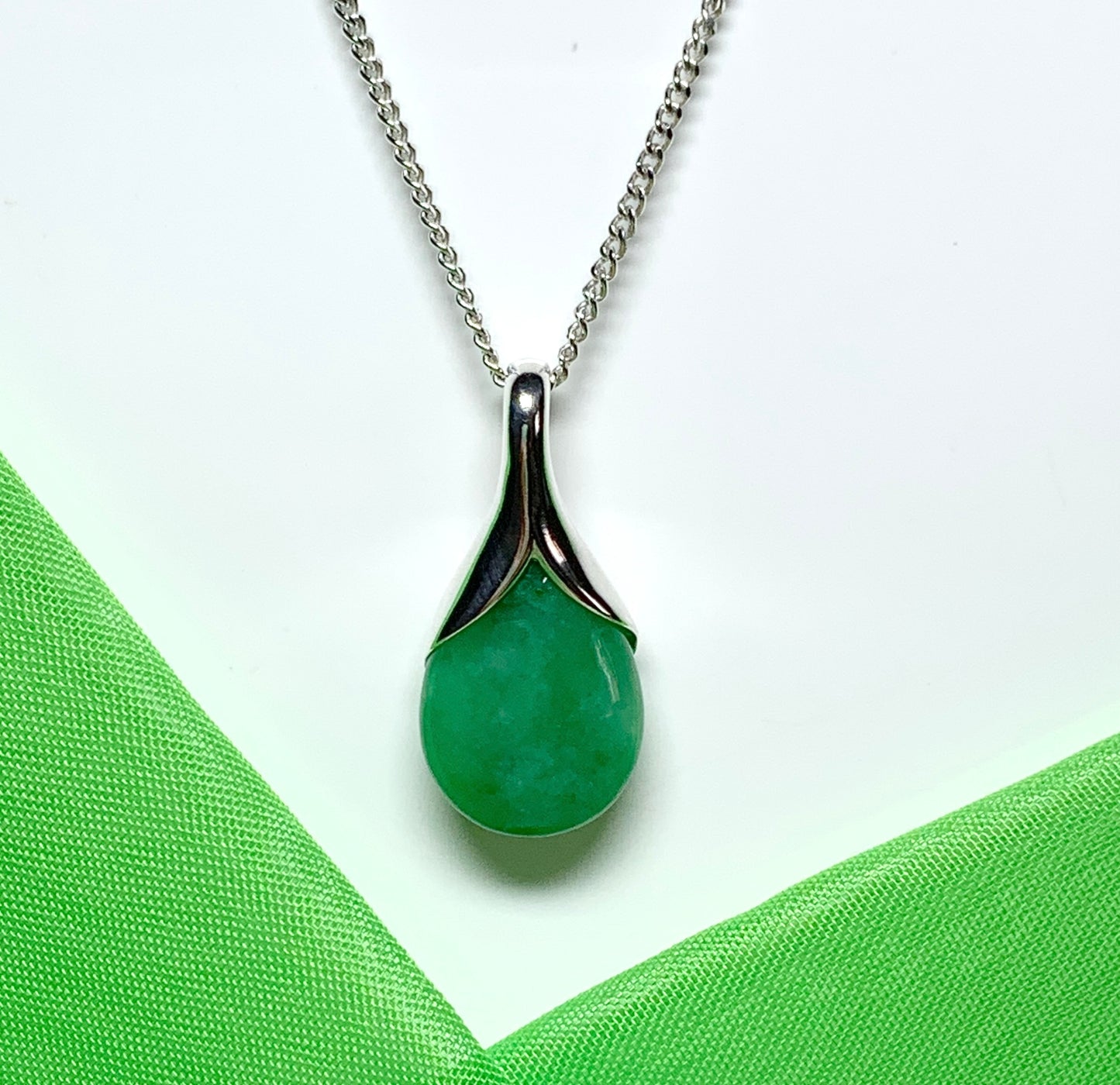 A real green jade necklace in a tear drop or pear shape pendant