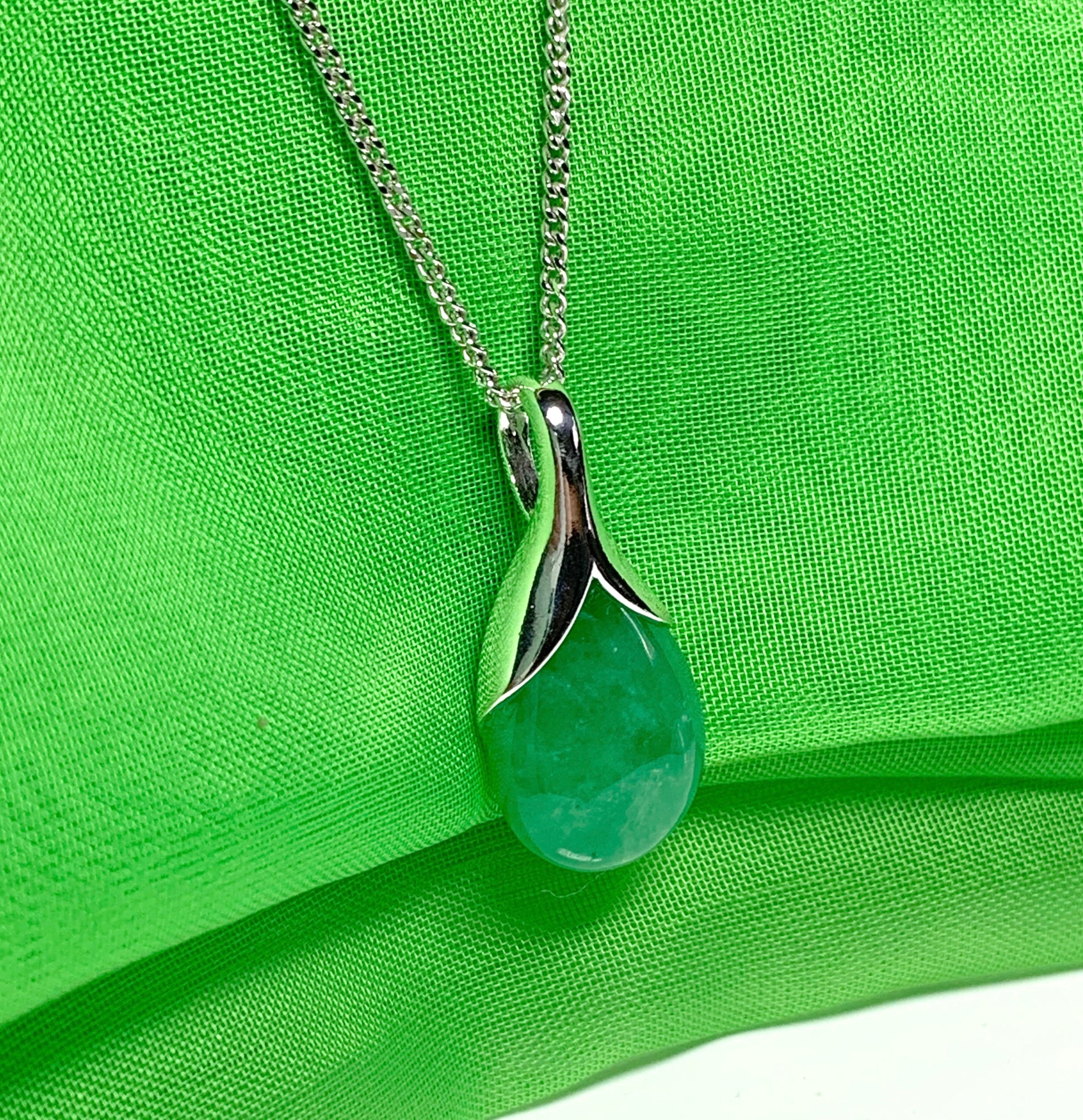 A real green jade necklace in a tear drop or pear shape