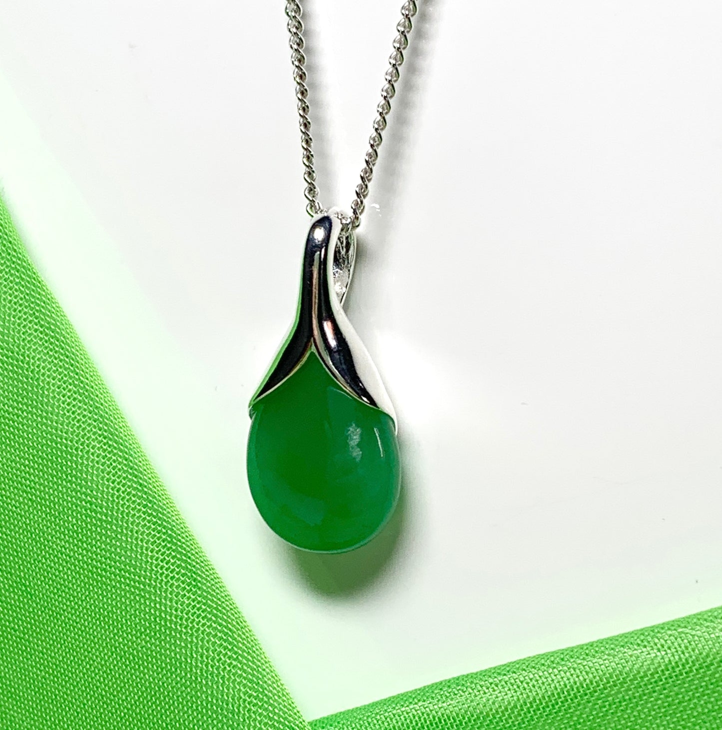 A real green jade necklace in a tear drop or pear shaped