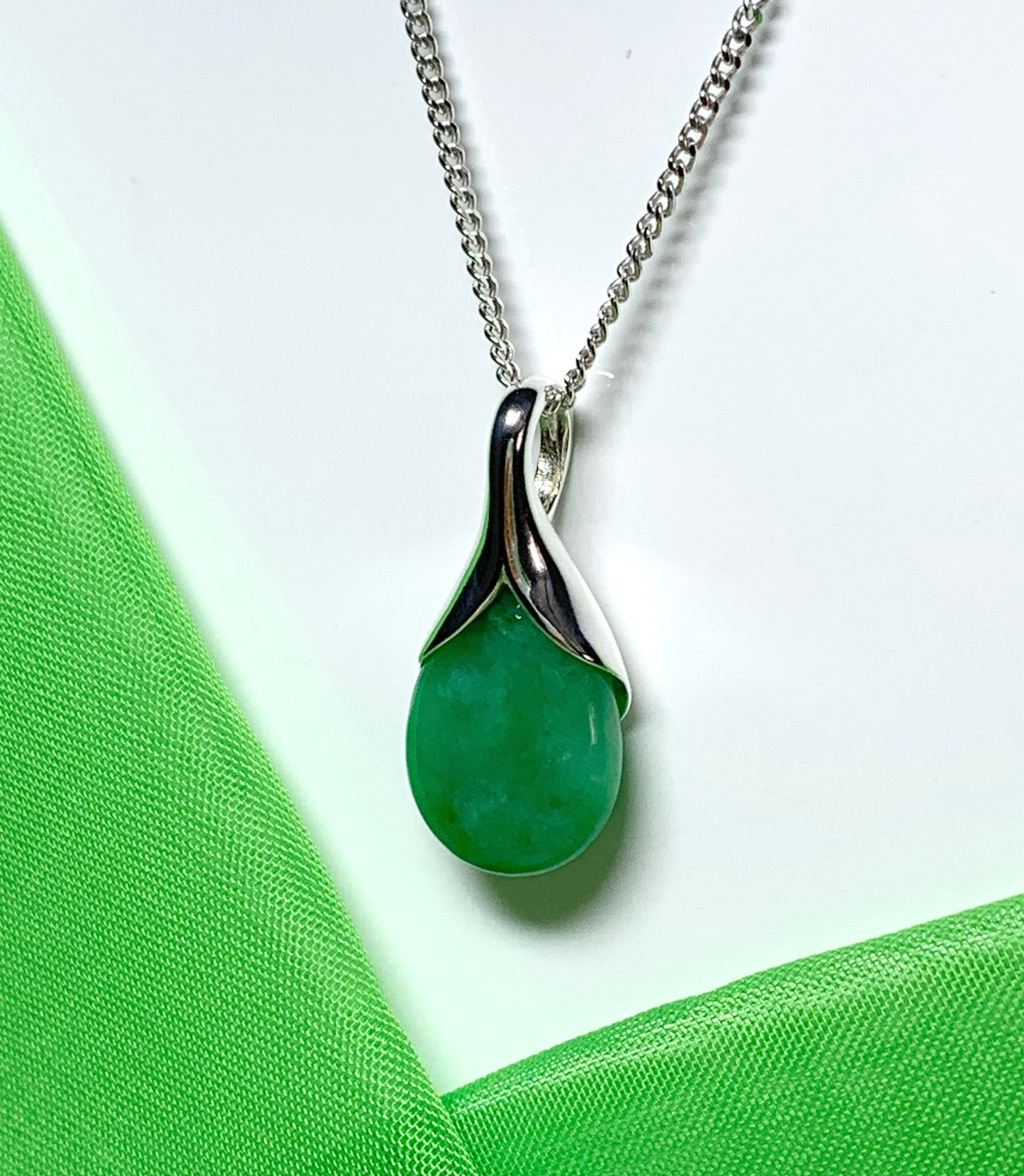 A real green jade necklace in a tear drop or pear shape pendant