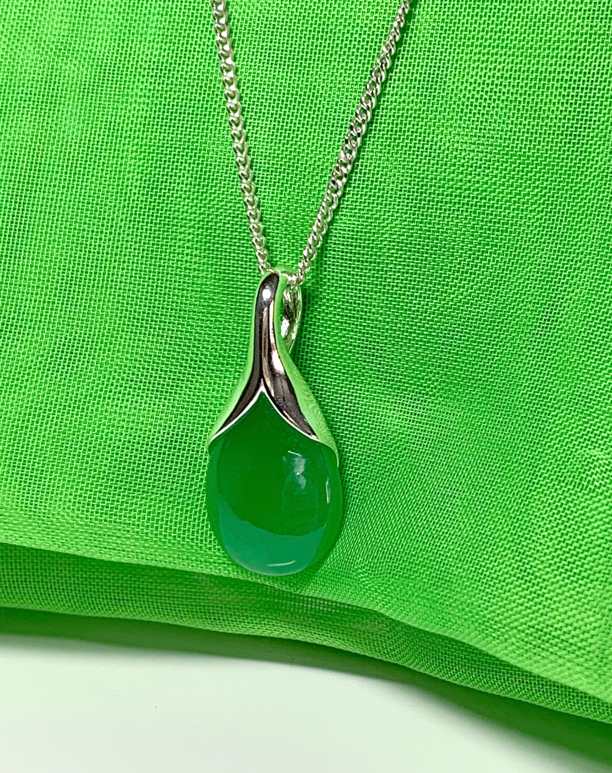 A real green jade necklace in a tear drop or pear shaped