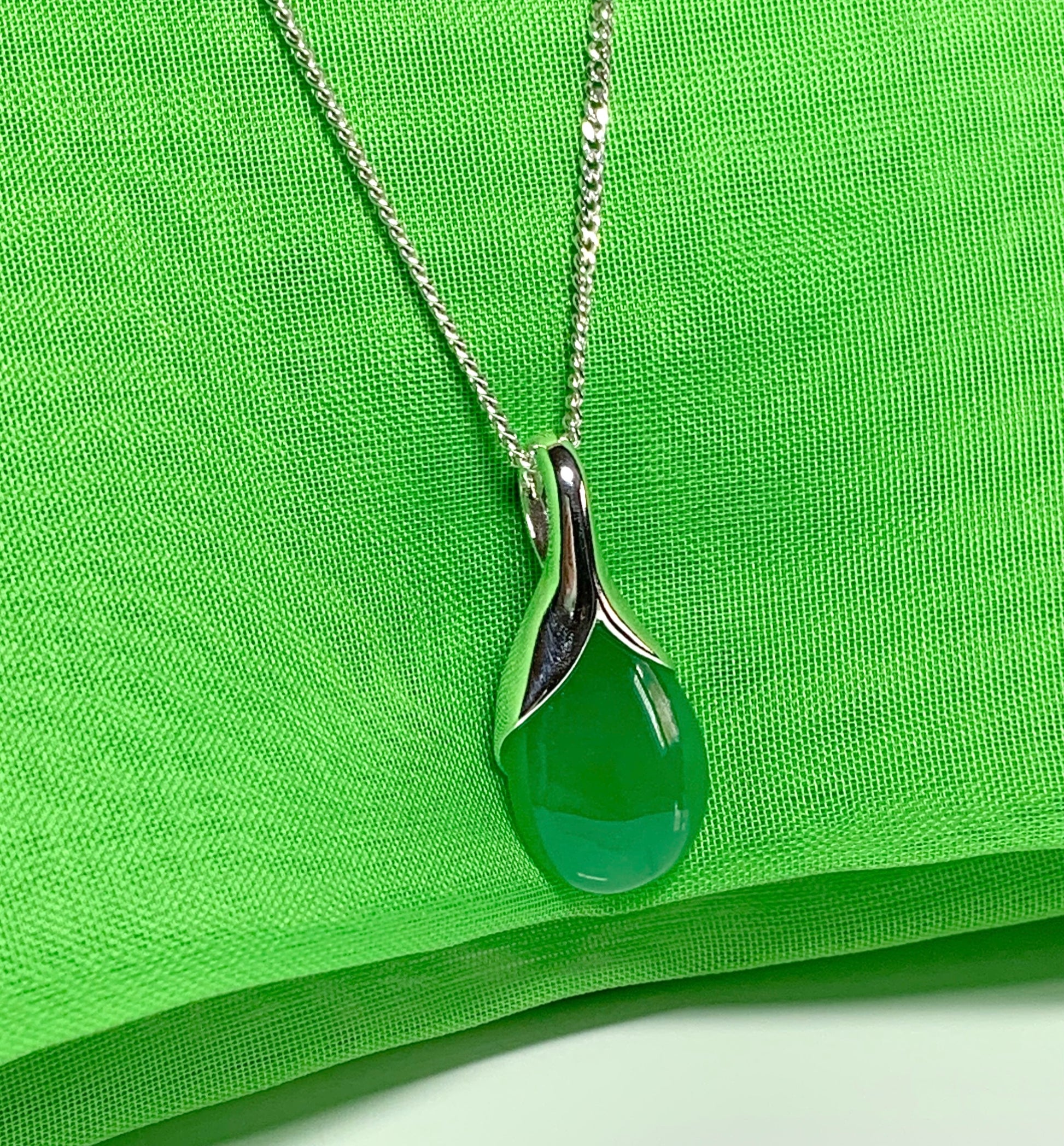 A real green jade necklace in a tear drop or pear shaped