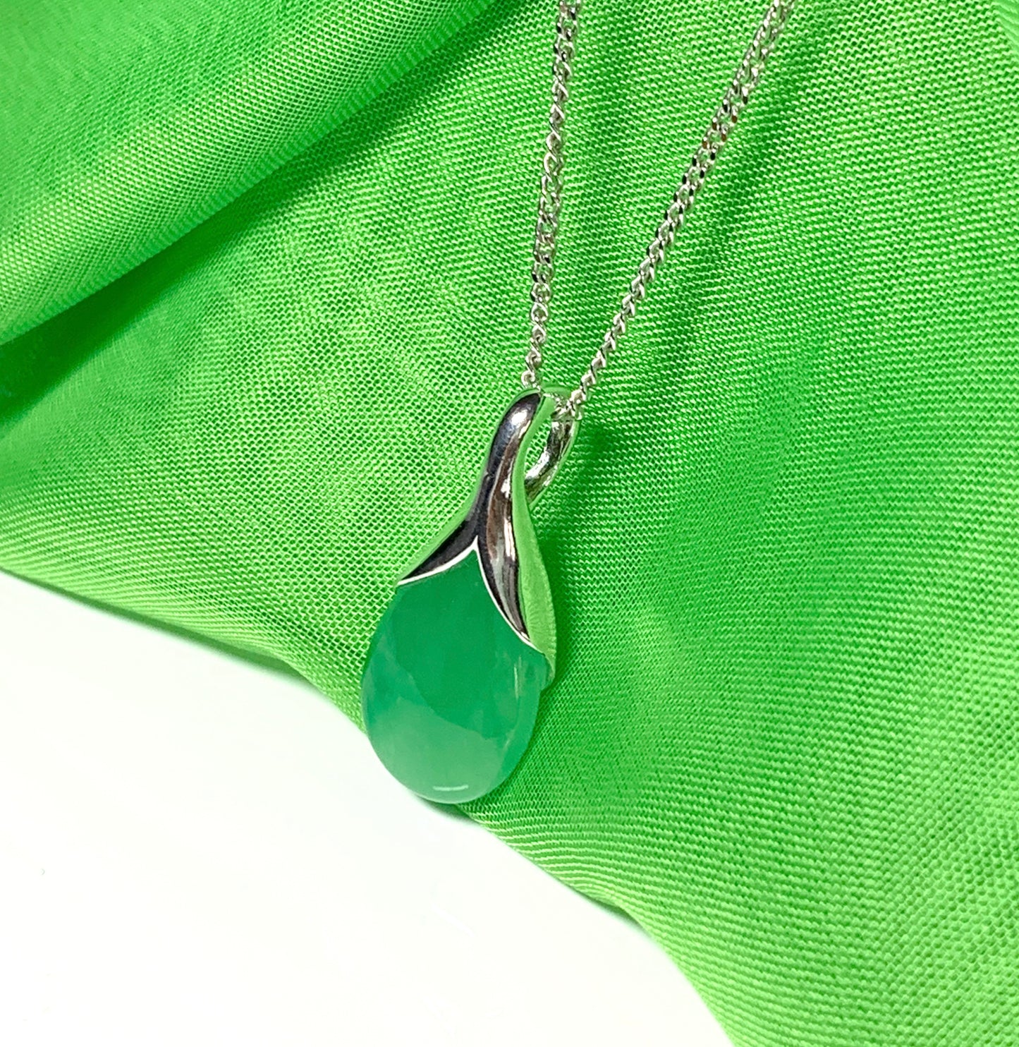 A real green jade necklace in a teardrop shaped or pear shape